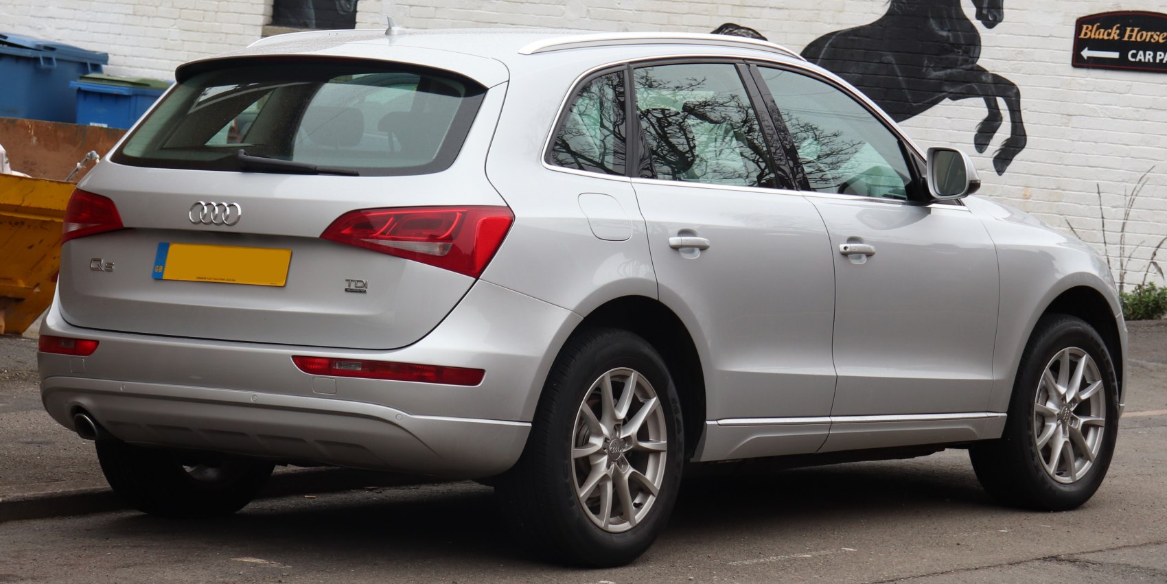 Rear-side view of silver SUV highlighting tail lights and alloy wheels