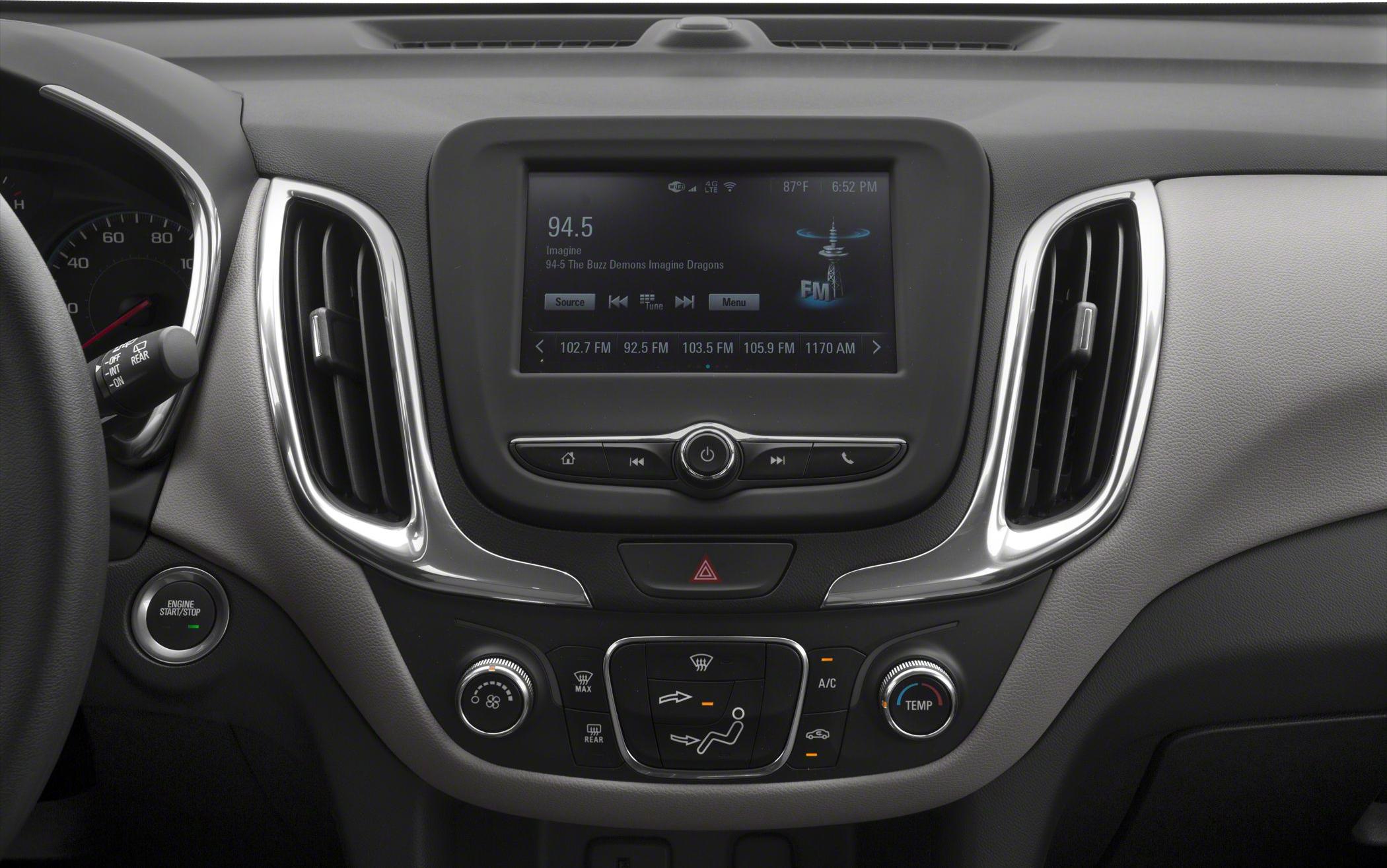 Infotainment screen, climate control knobs, push-button start in vehicle dashboard