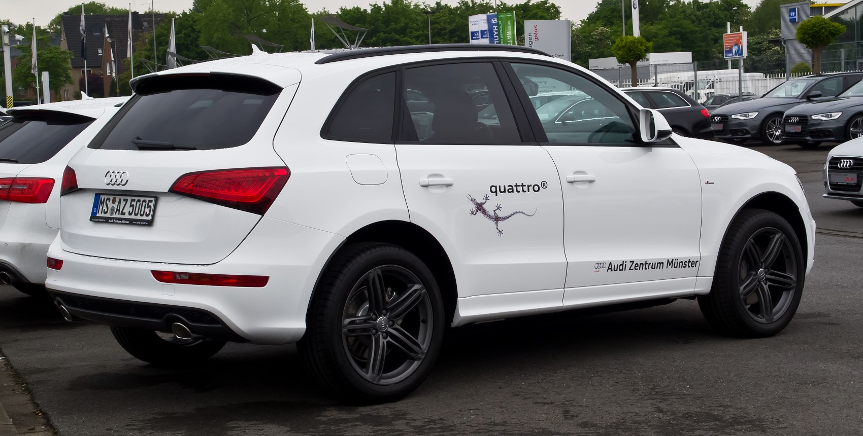 White mid-sized SUV with sport rims and LED rear lights