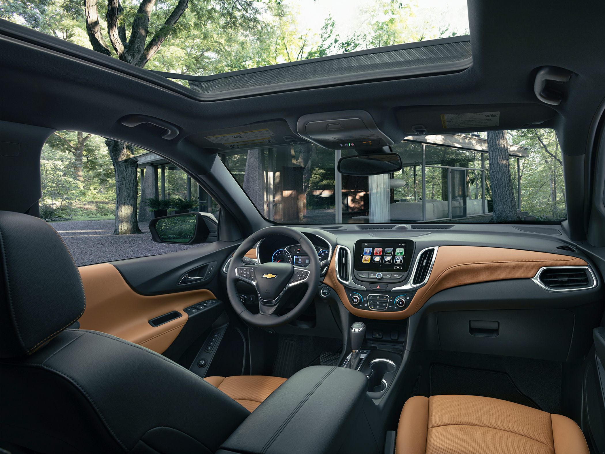 Panoramic sunroof and leather-trimmed SUV interior with infotainment display