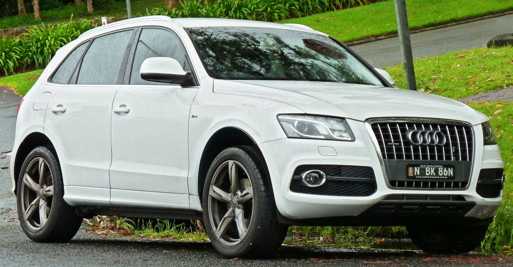 White SUV side-front view with LED headlights and alloy wheels