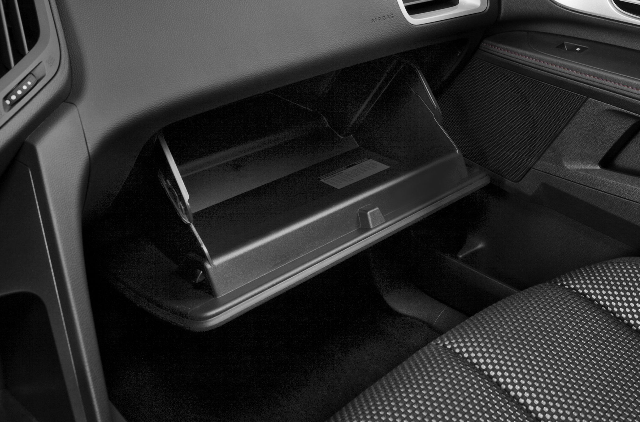 Open glove compartment and passenger seat fabric texture