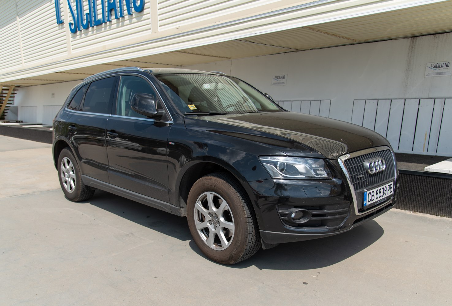 Front-side view of a black compact luxury SUV with distinct grille and alloy wheels.