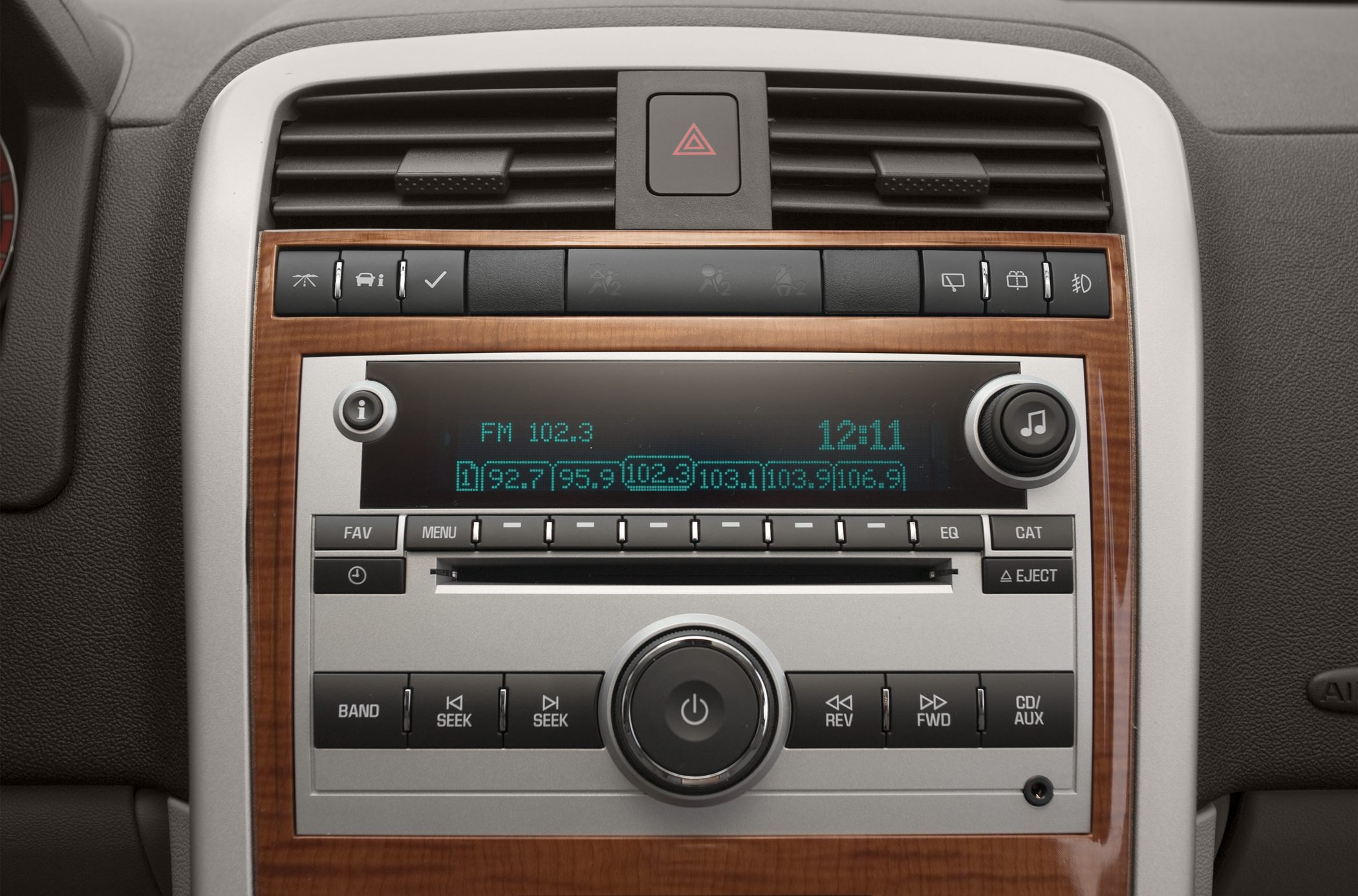 Radio system and dashboard control buttons with wood finish trim