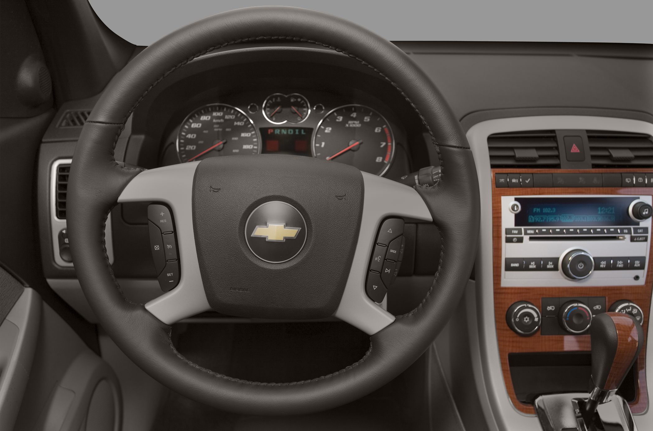 Steering wheel with control buttons and dashboard with radio and climate controls