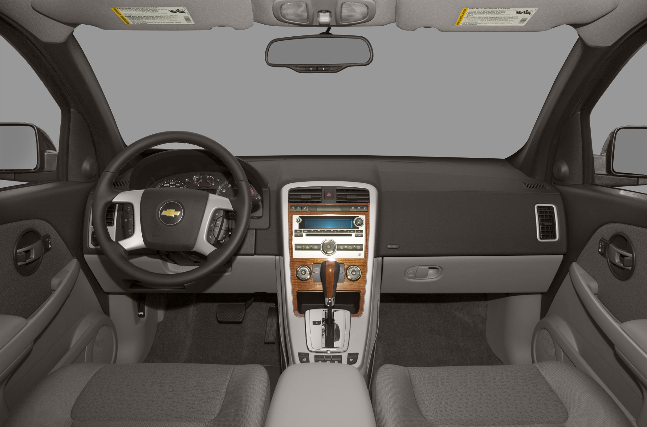 Central wood-trimmed console and steering wheel with controls