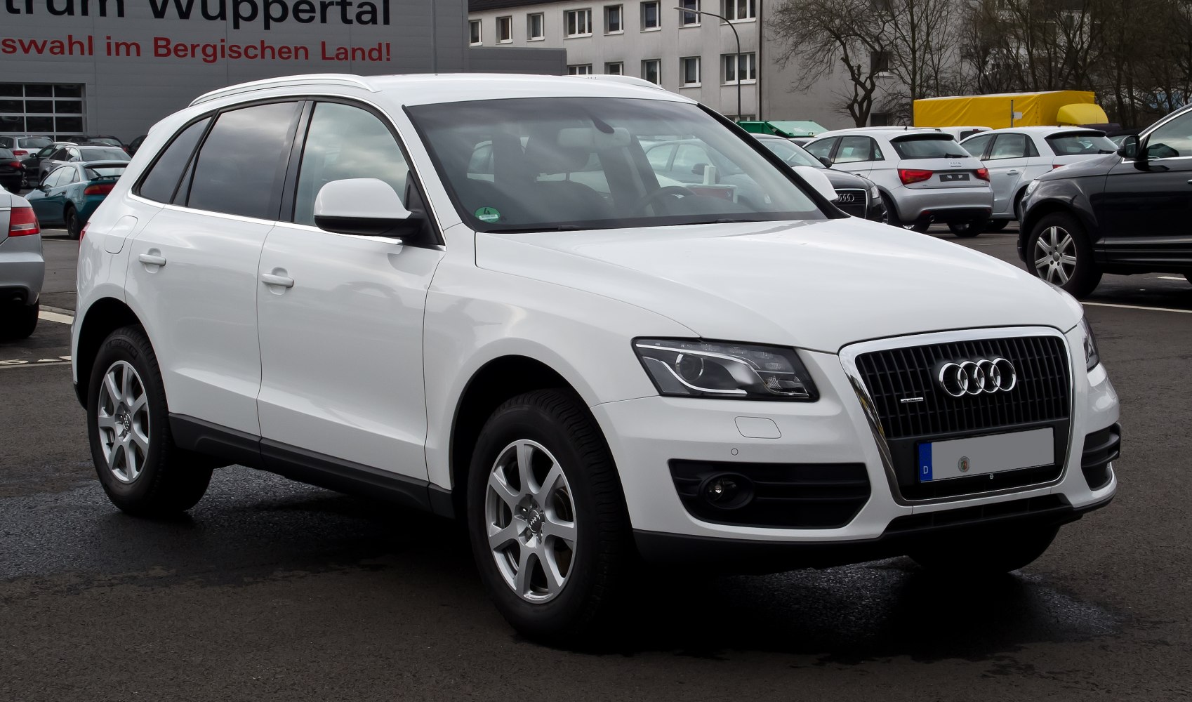 White luxury SUV with distinctive grille and aluminum wheels