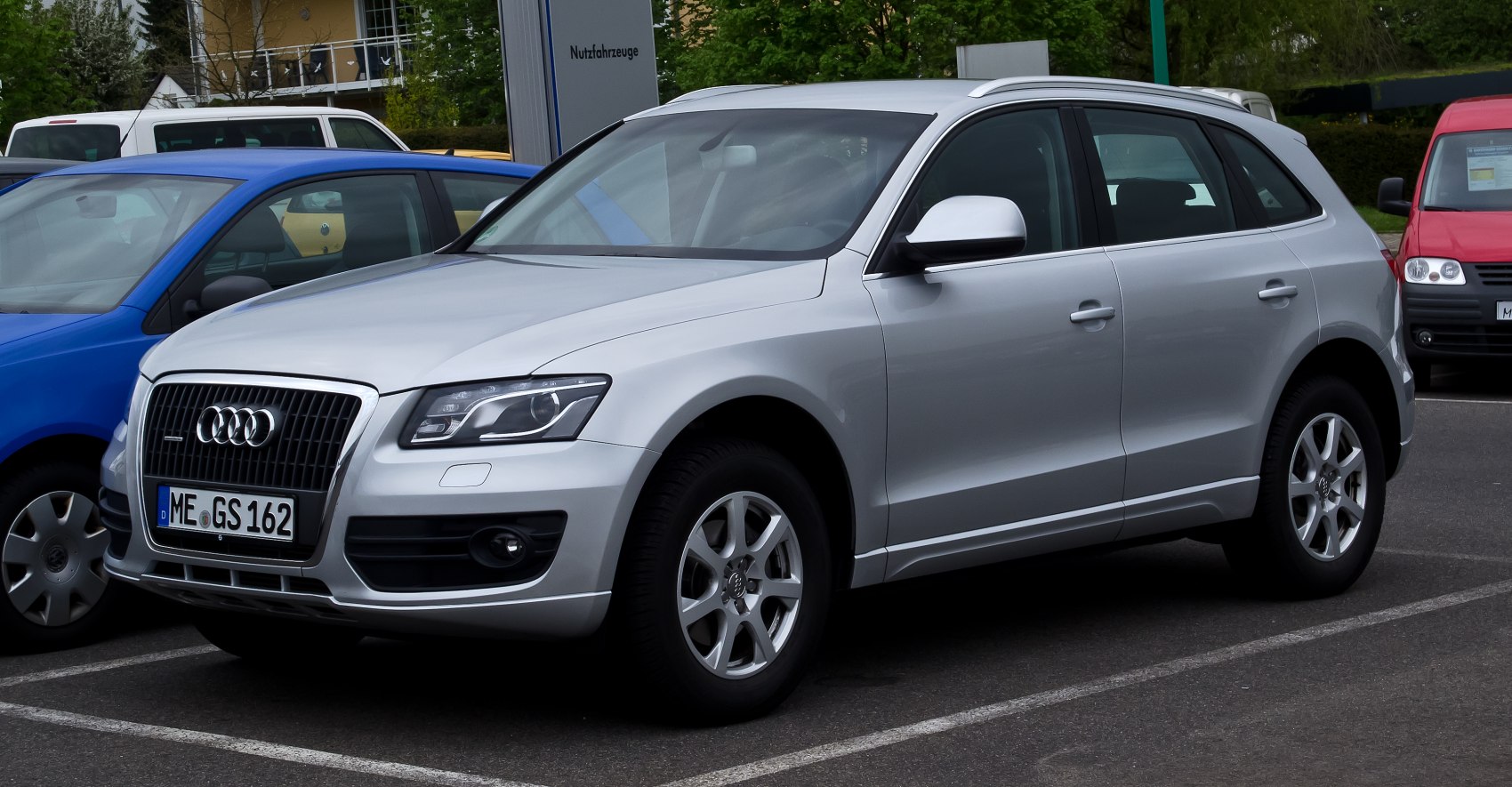 Front-side view of silver mid-size SUV with LED headlights and alloy wheels