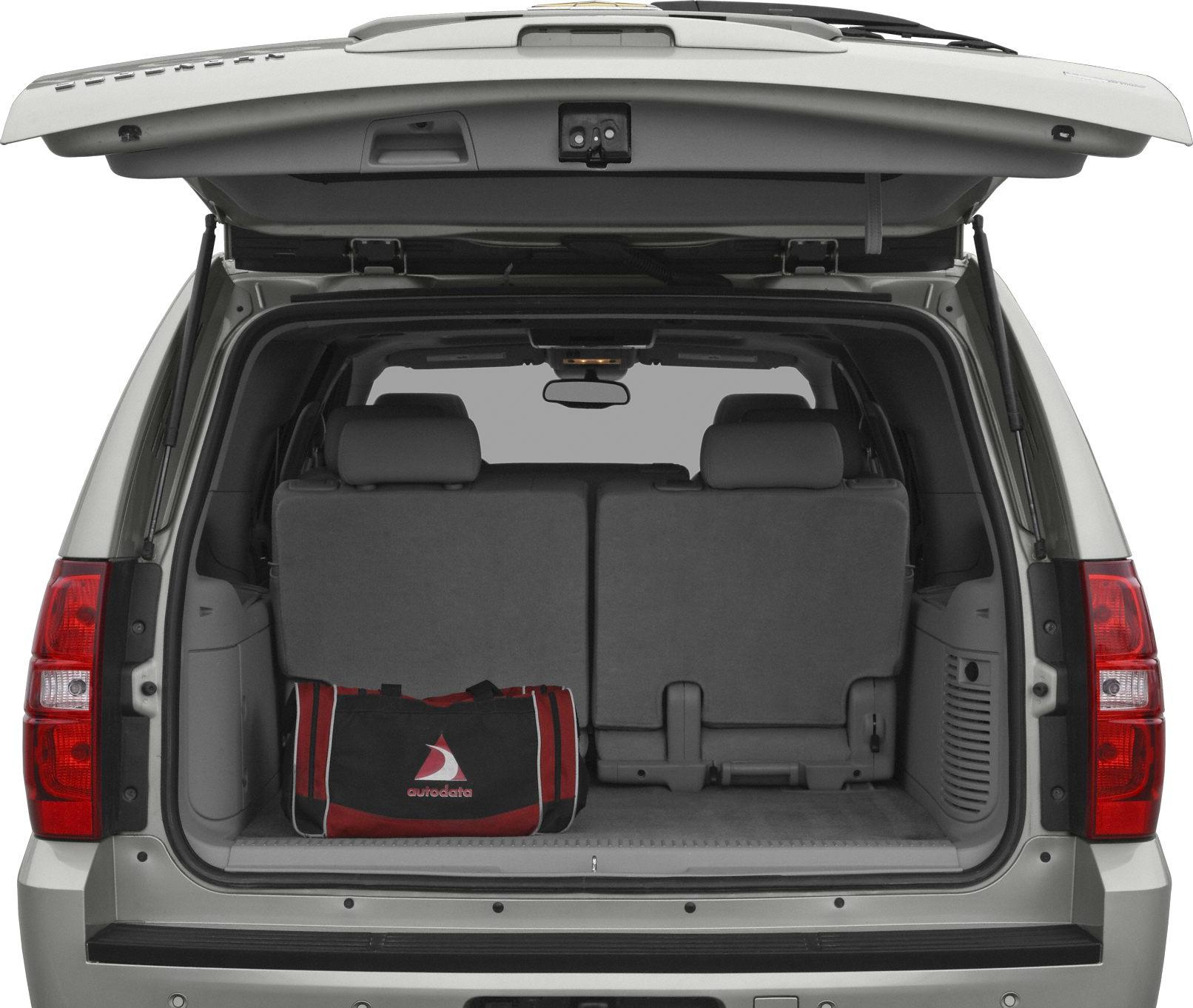 Open rear tailgate with upright seats and cargo space in a large SUV