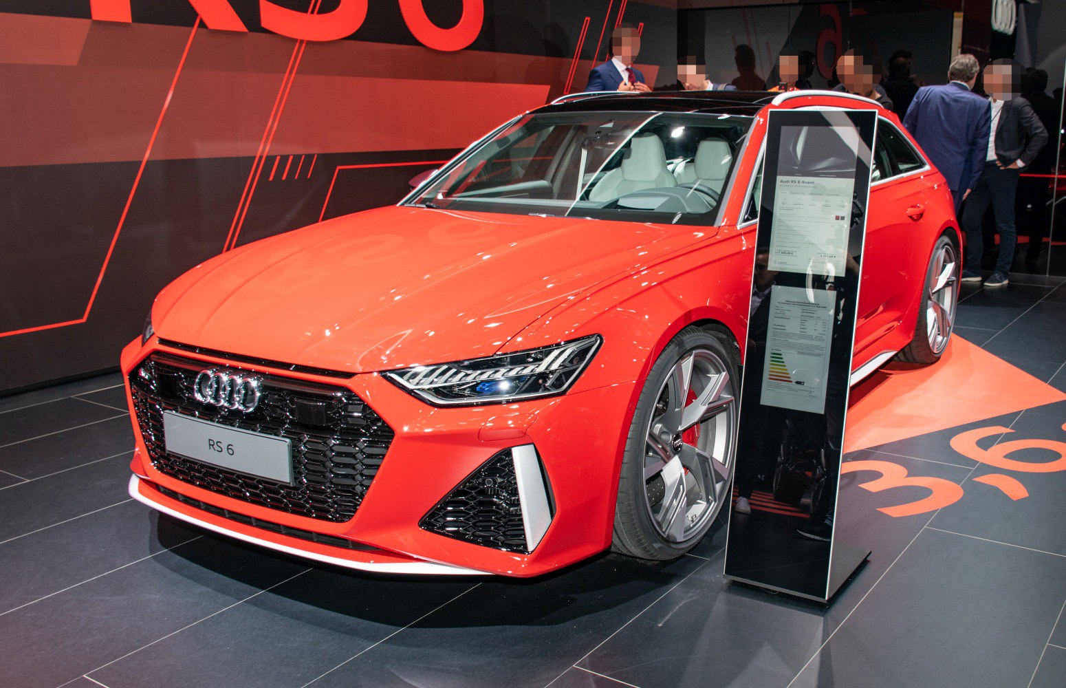 Red sport hatchback with aggressive front grille and unique alloy wheels