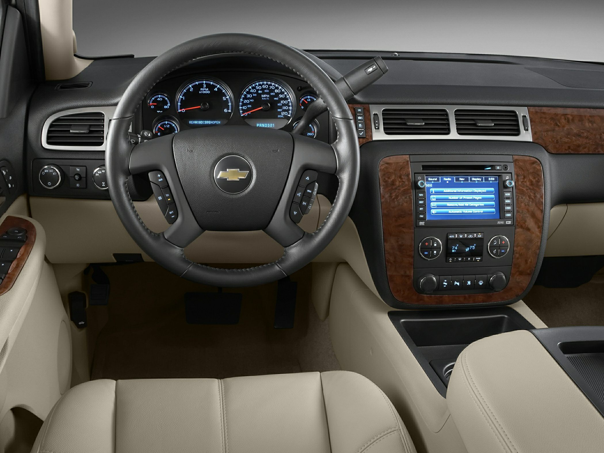 Steering wheel and dashboard with infotainment and wood trim