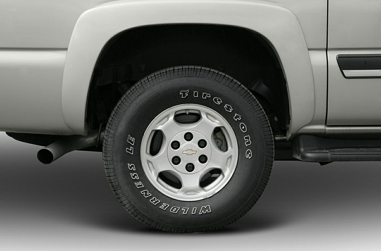 Rear wheel with Firestone Wilderness LE tire and exhaust pipe near rear fender