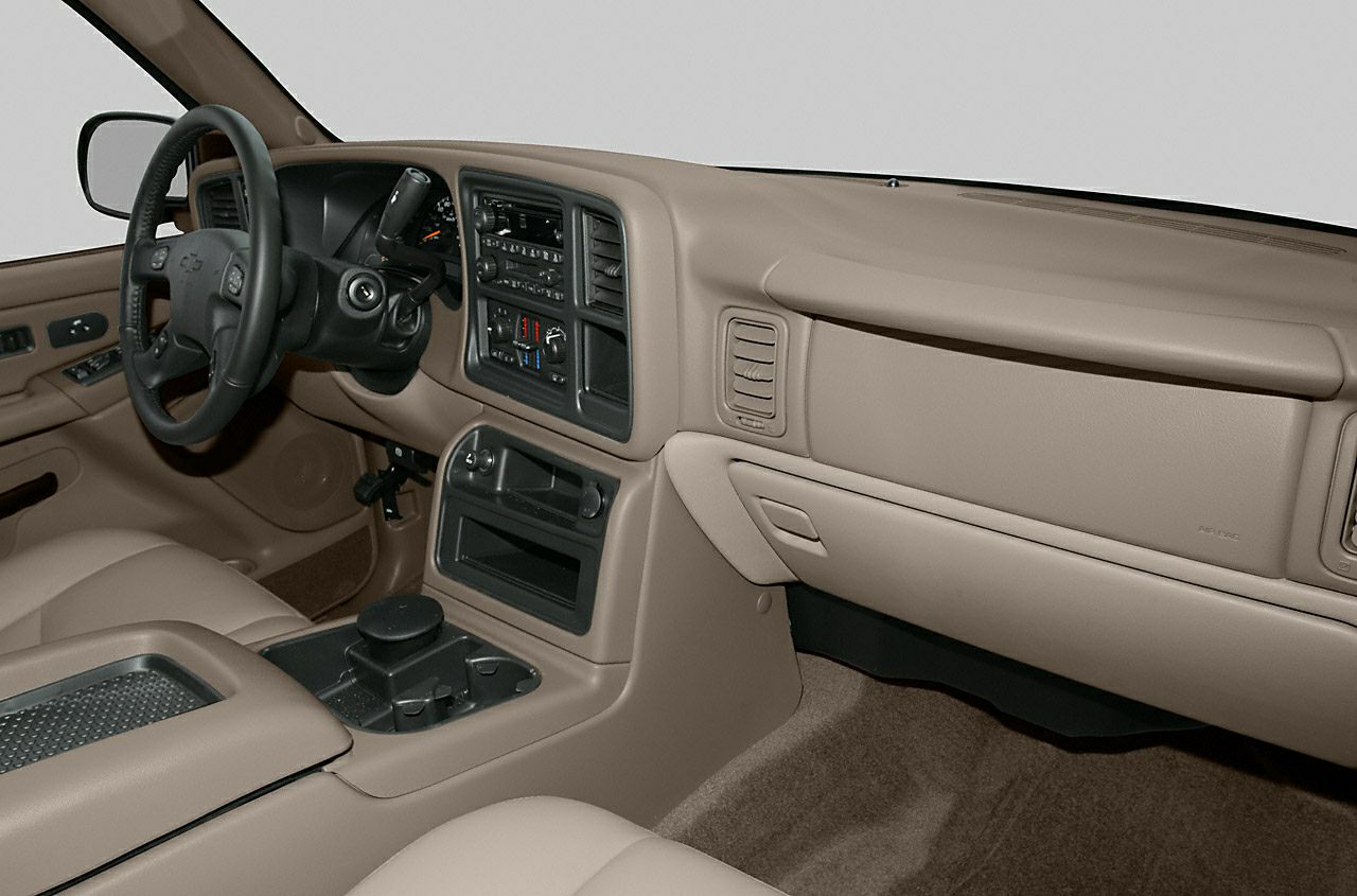 Beige dashboard and center console with classic controls and steering wheel