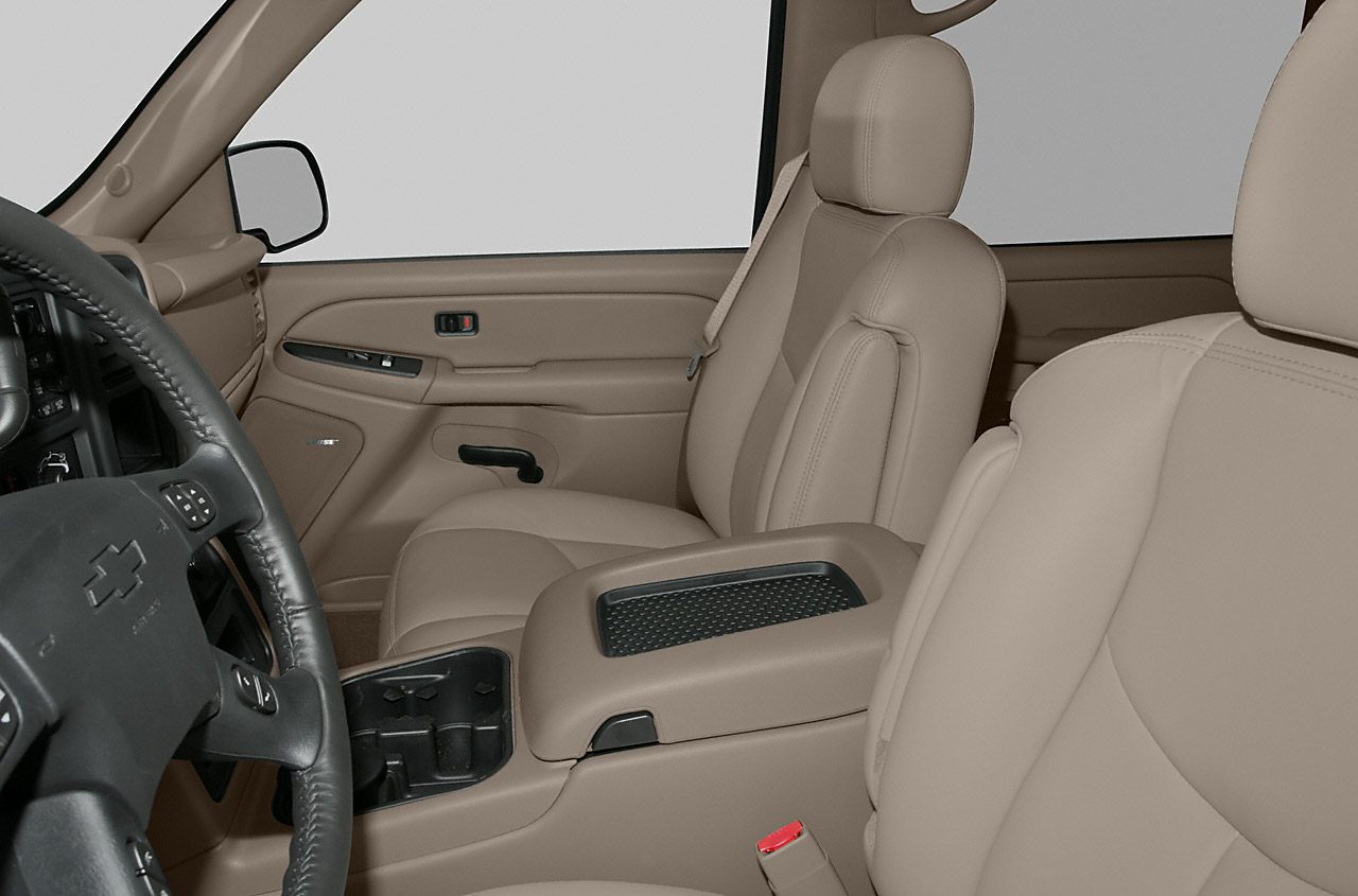 Beige leather front seats with center console and steering wheel details