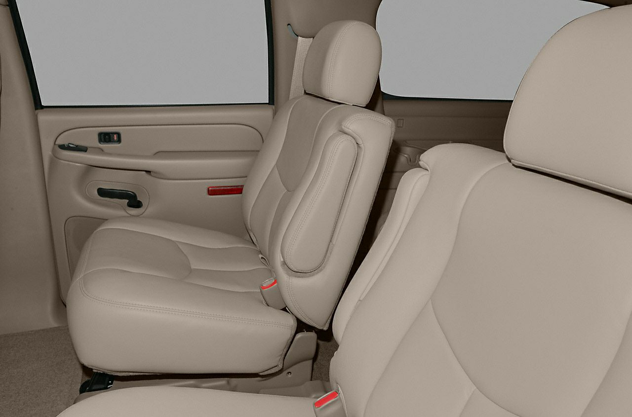 Beige leather interior SUV seats with seatbelts and door panel