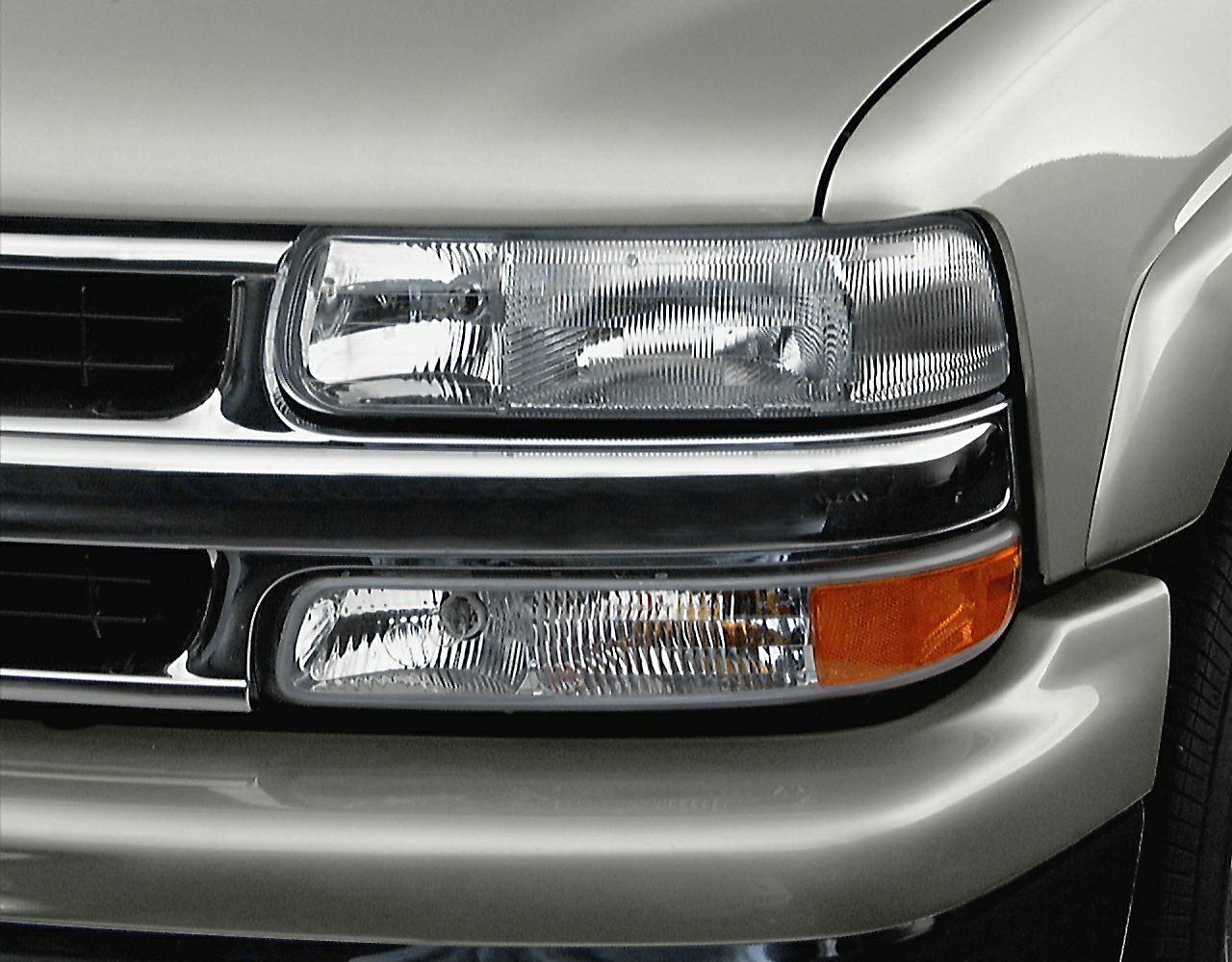 Close-up view of front headlight and grille assembly with turn signal