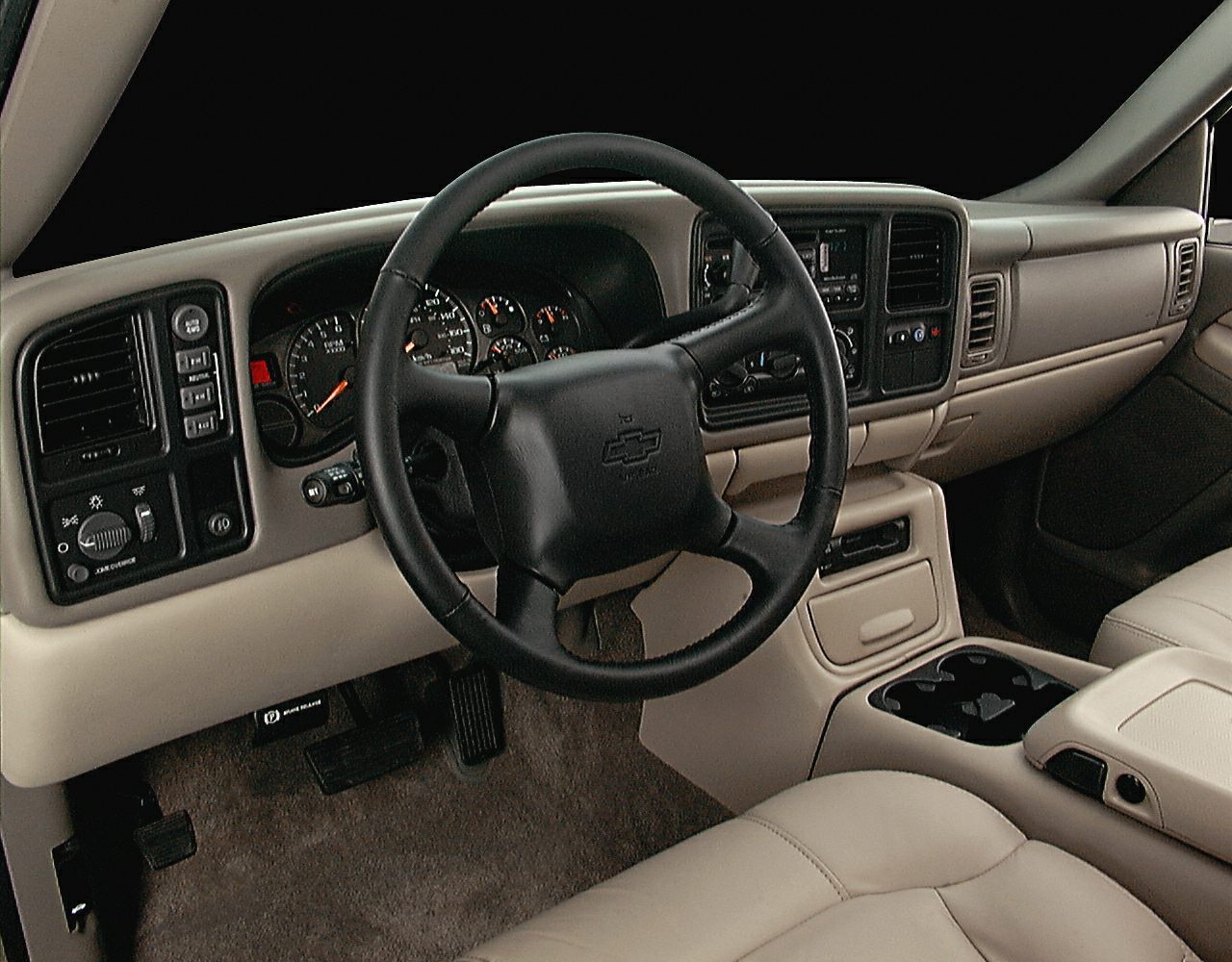 Steering wheel and dashboard with instrumentation and center console in beige interior