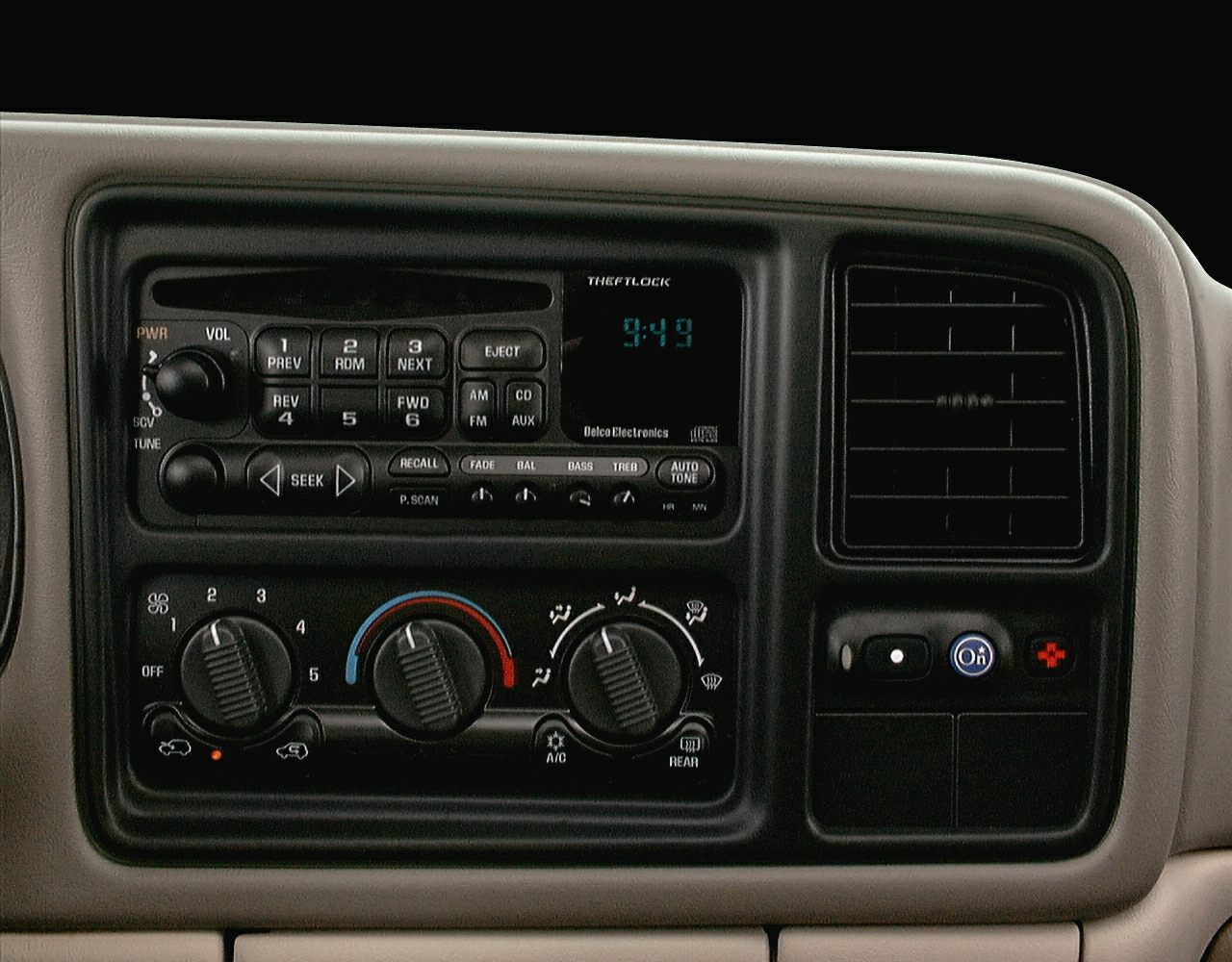 Vehicle dashboard radio with digital clock and climate control knobs