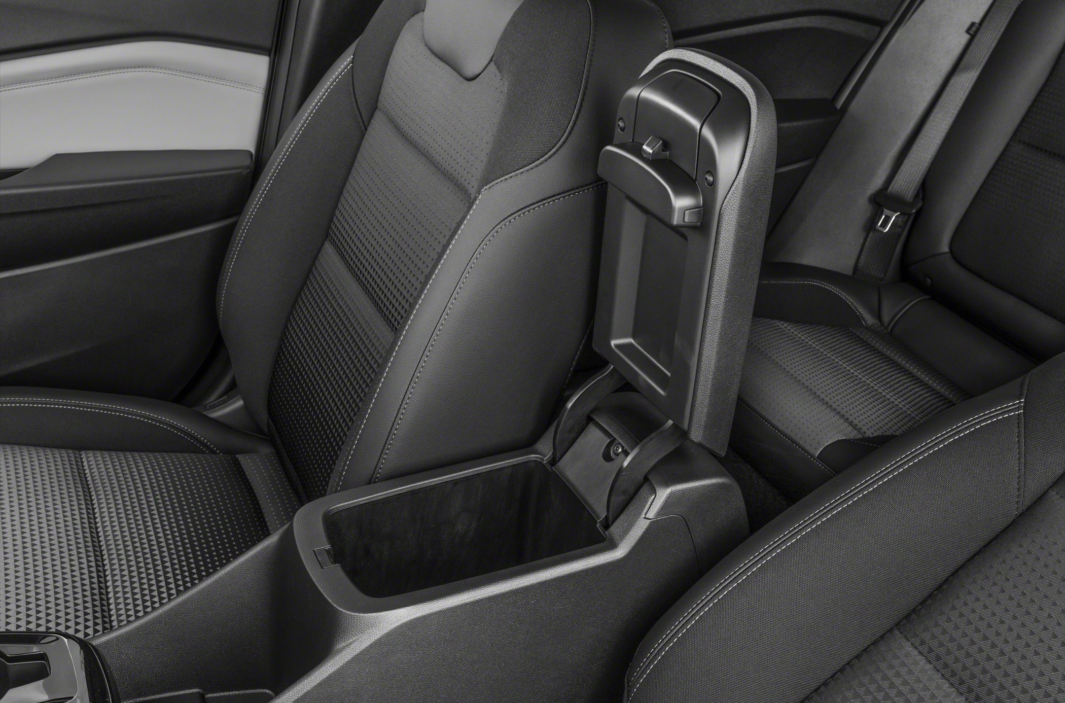 Center console storage compartment with modern patterned seats.