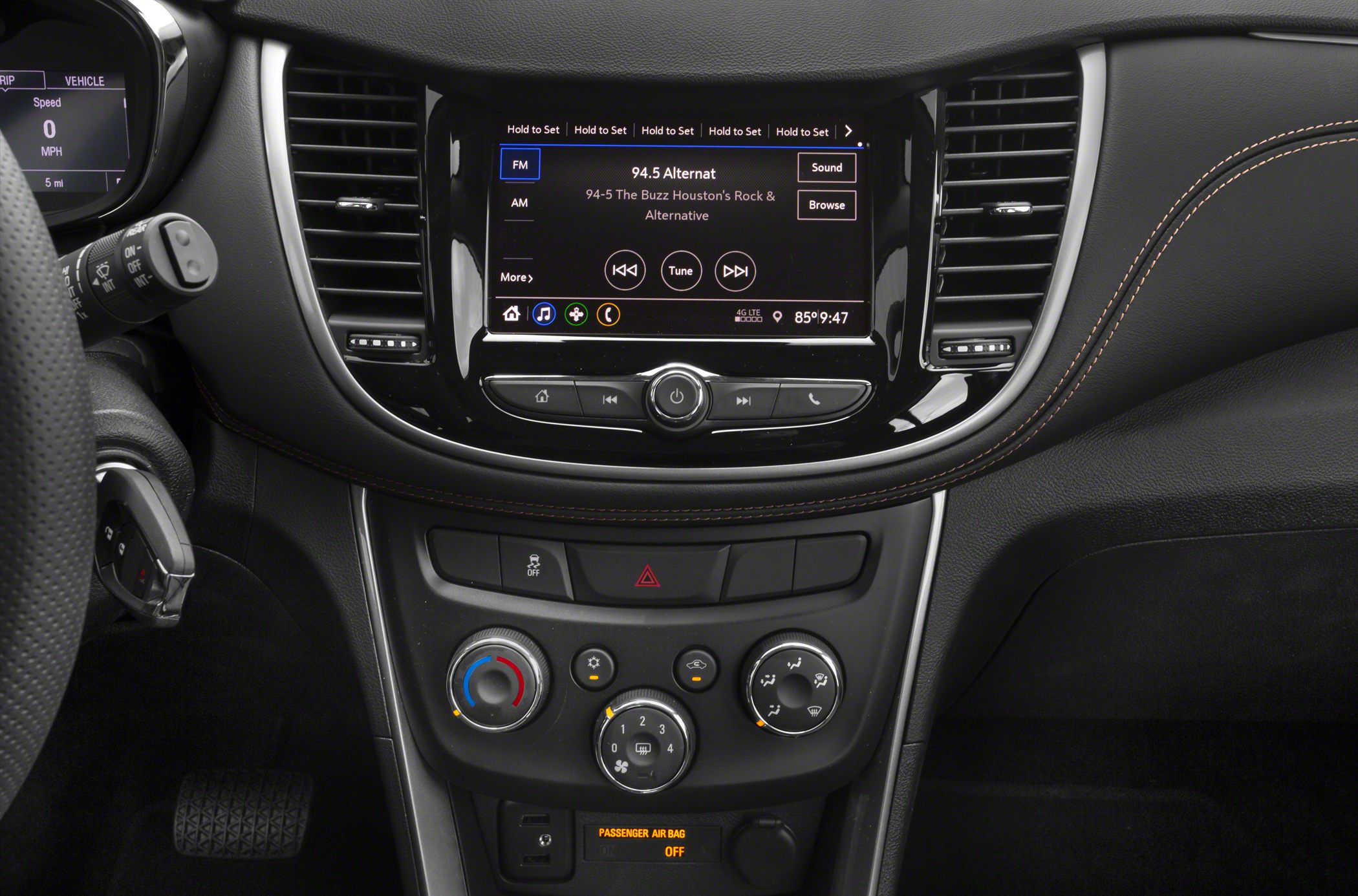 Car interior dashboard with touchscreen infotainment and climate controls