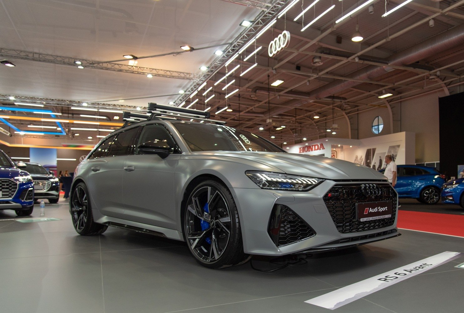 Sporty luxury wagon with aerodynamic shape, black alloy wheels, and roof rack.
