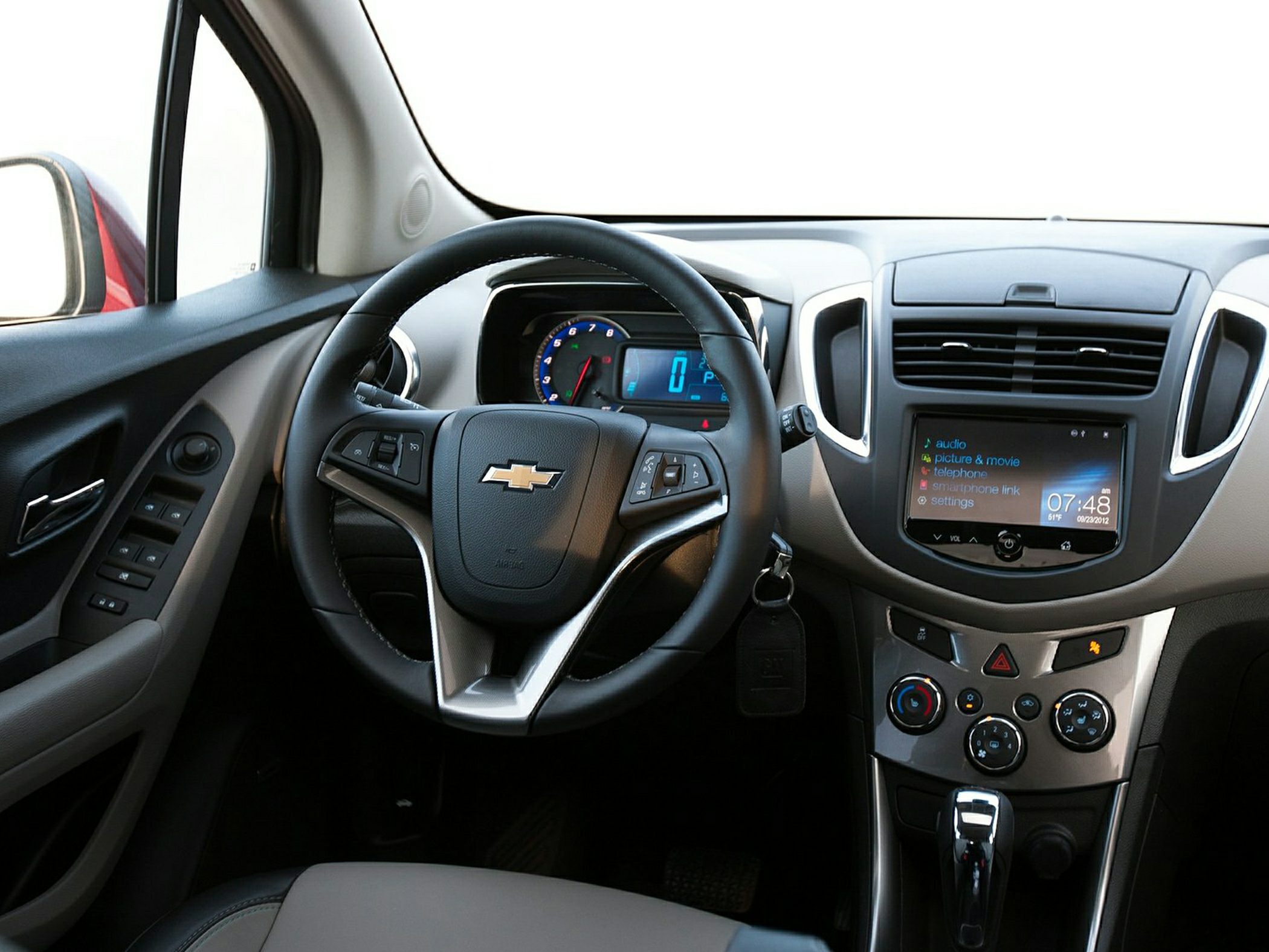 Dashboard, steering wheel, and center console with touchscreen infotainment system