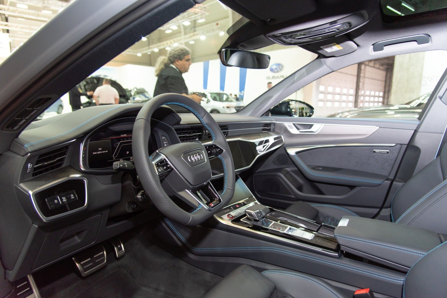 Modern luxury car interior with digital dashboard and leather details