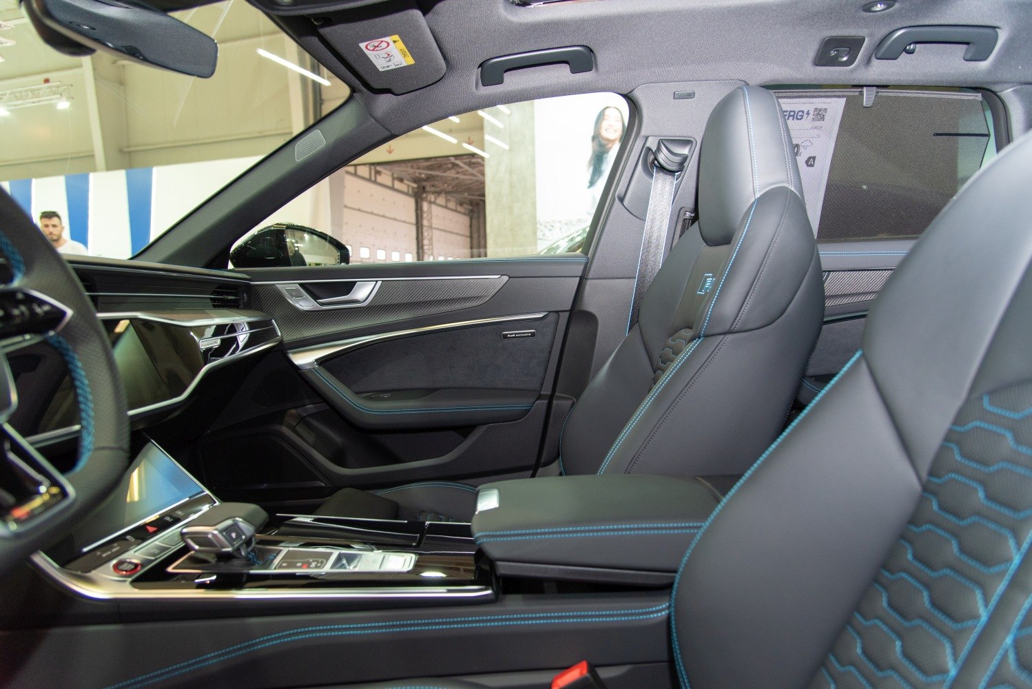 Luxury interior with blue contrast stitching and modern control panel