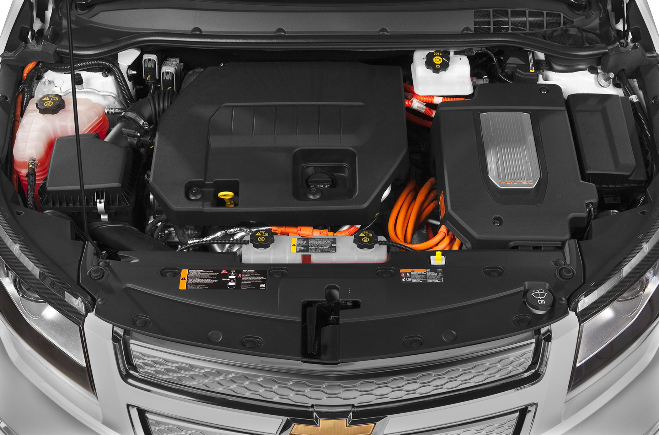 Electric engine bay with orange high-voltage cables and black protective covers.