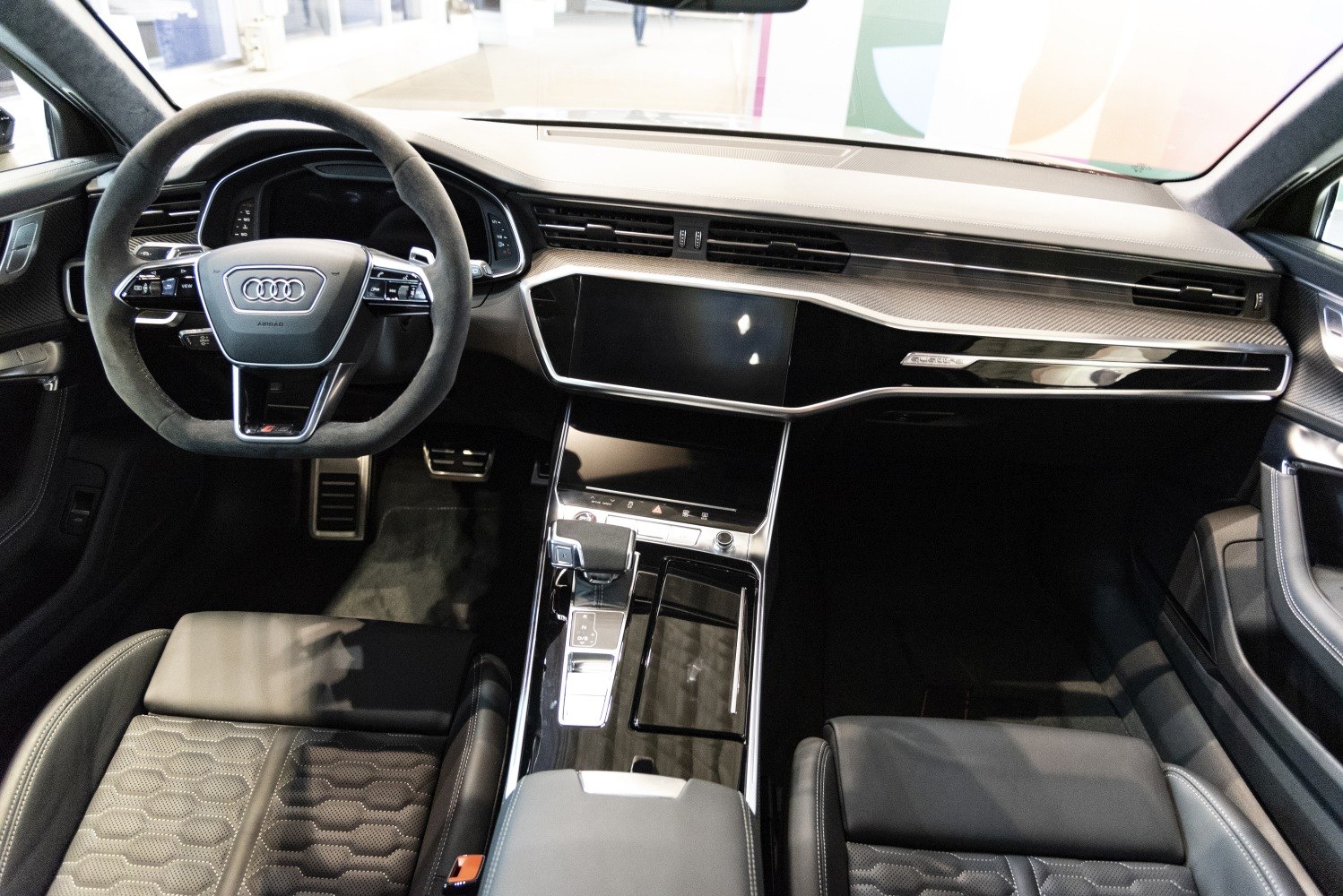 Modern luxury car interior with digital displays and advanced controls