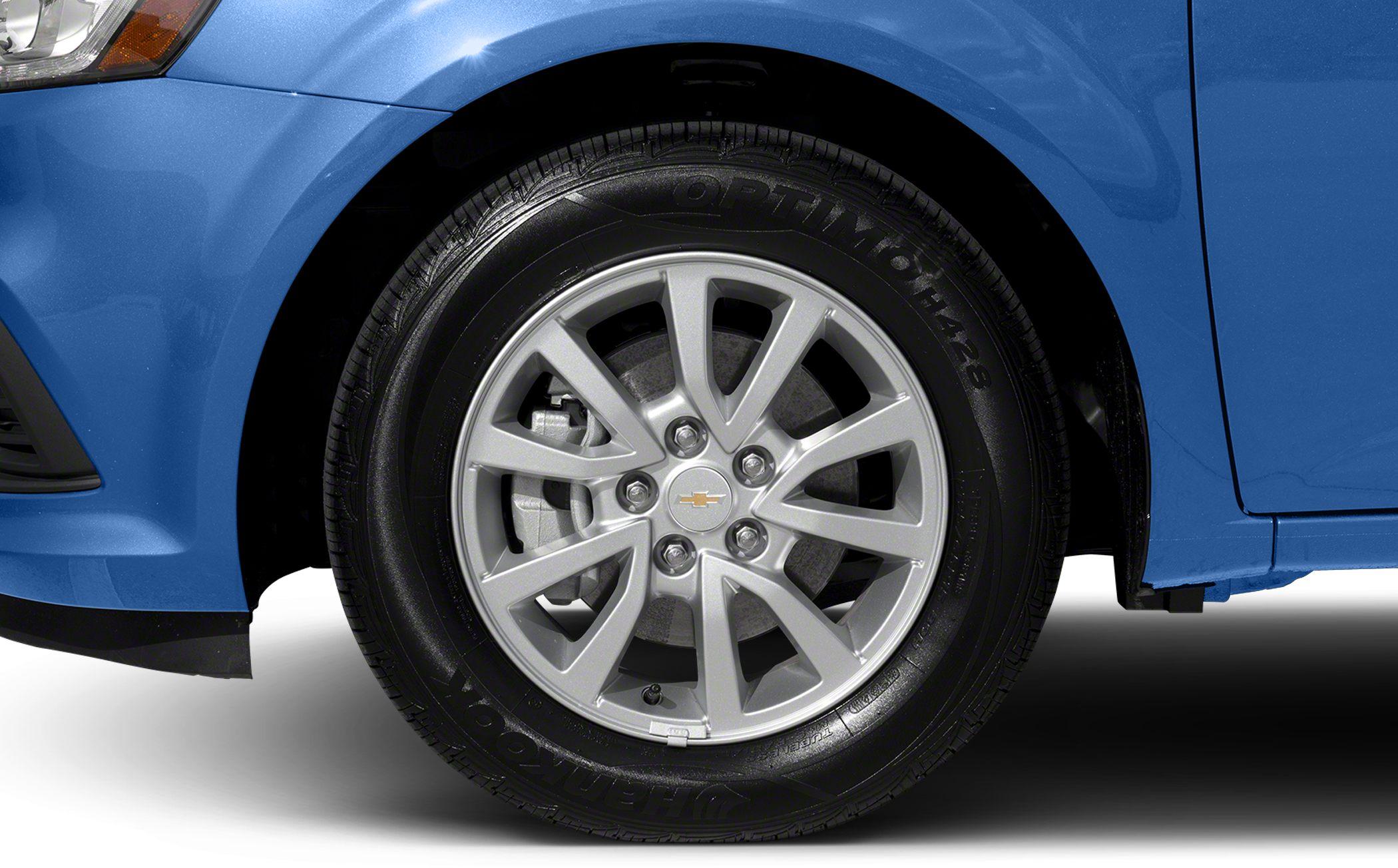 Close-up alloy wheel and Hankook tire on blue compact sedan.