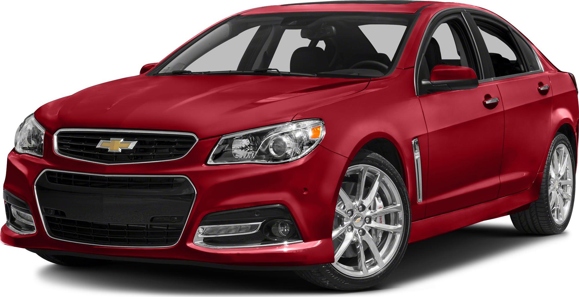 Front side view of red sedan with chrome wheels and grille