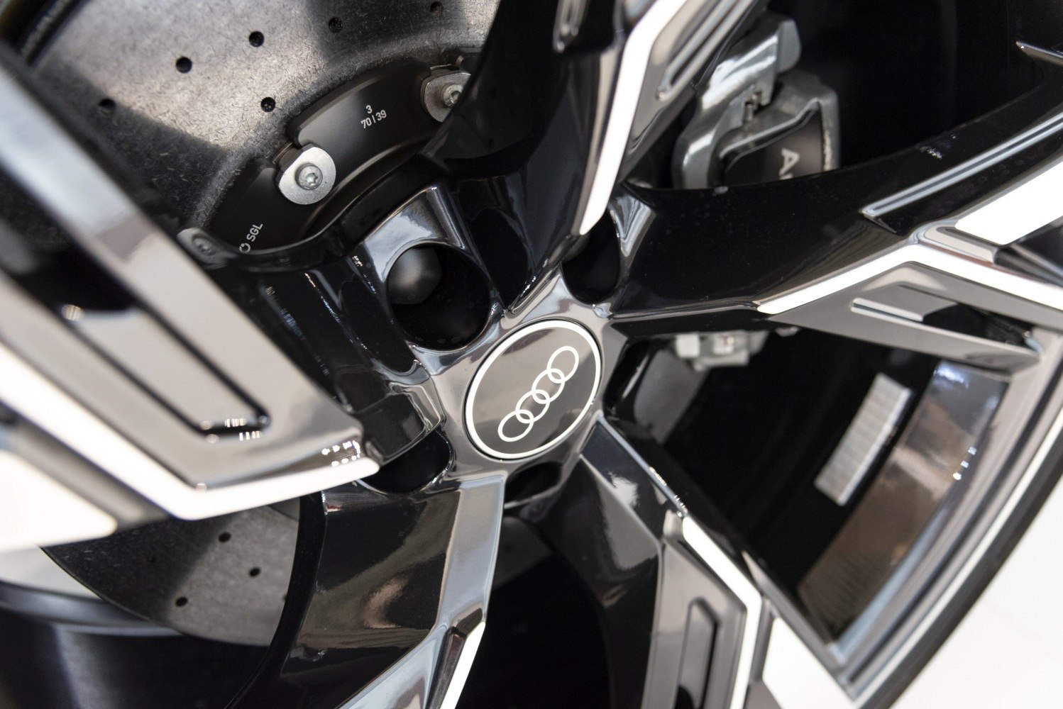 Close-up of luxury alloy wheel and drilled brake disc with caliper.