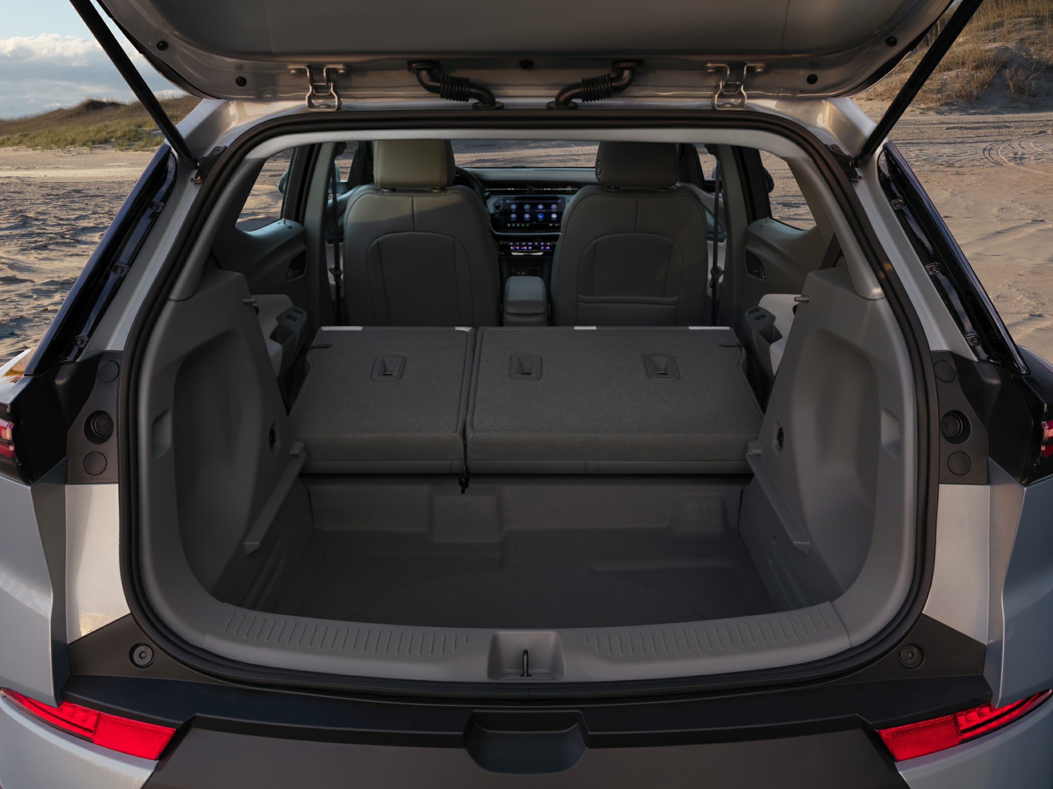 Folded rear seats and spacious cargo area in compact electric SUV