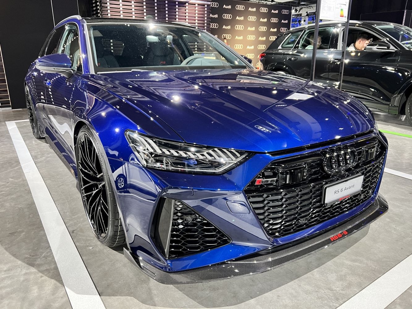 Blue vehicle with aggressive front grille and large black wheels