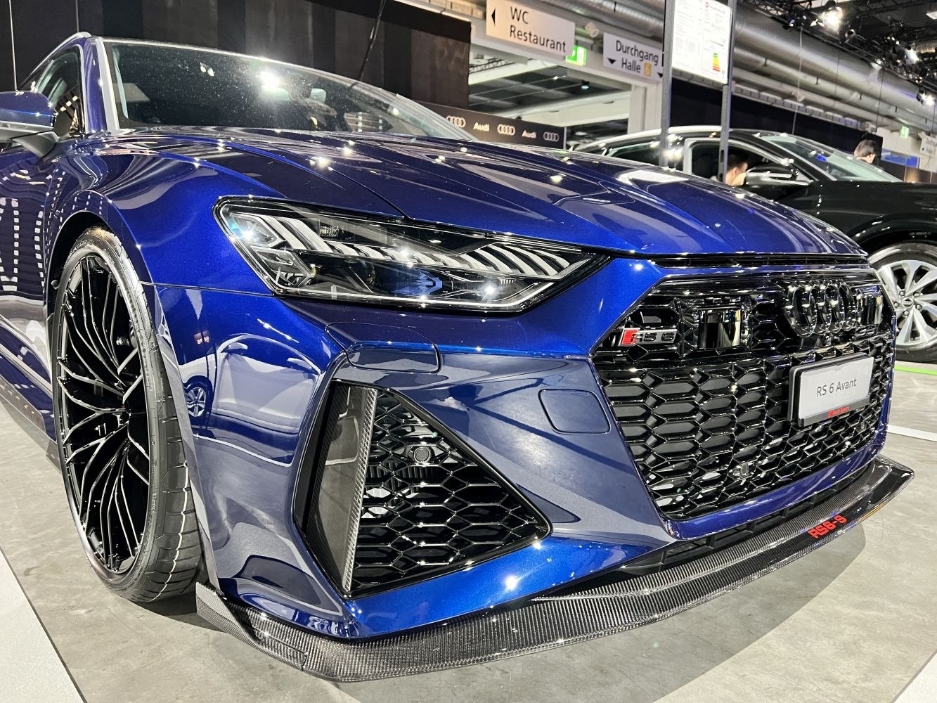 Close-up of front grille, headlights, and carbon fiber splitter