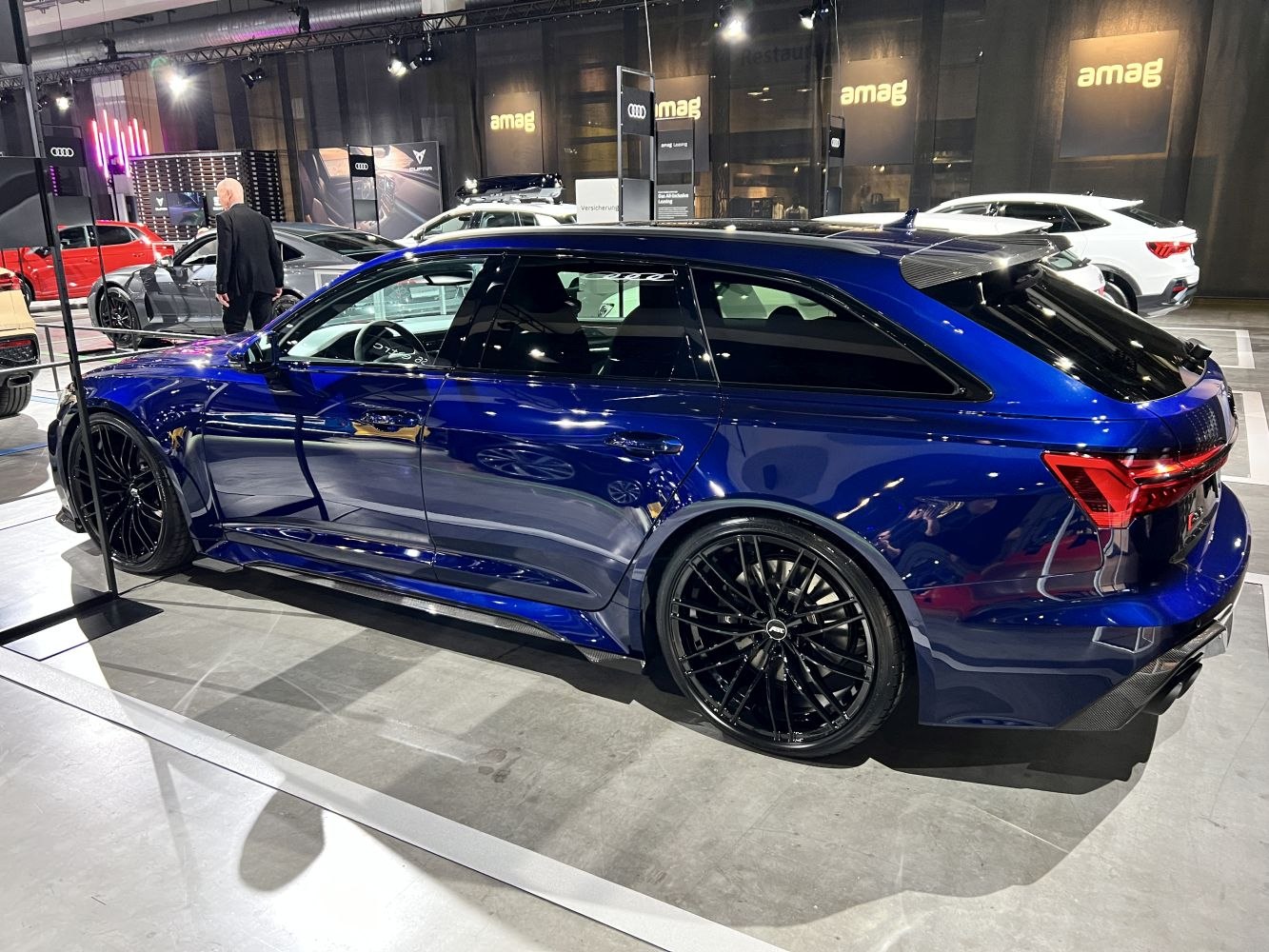 Station wagon with black multi-spoke wheels and sleek blue body