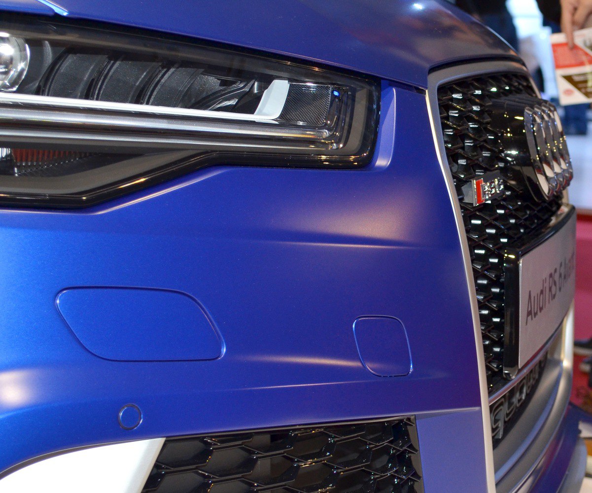 Close-up of front headlight and honeycomb grille