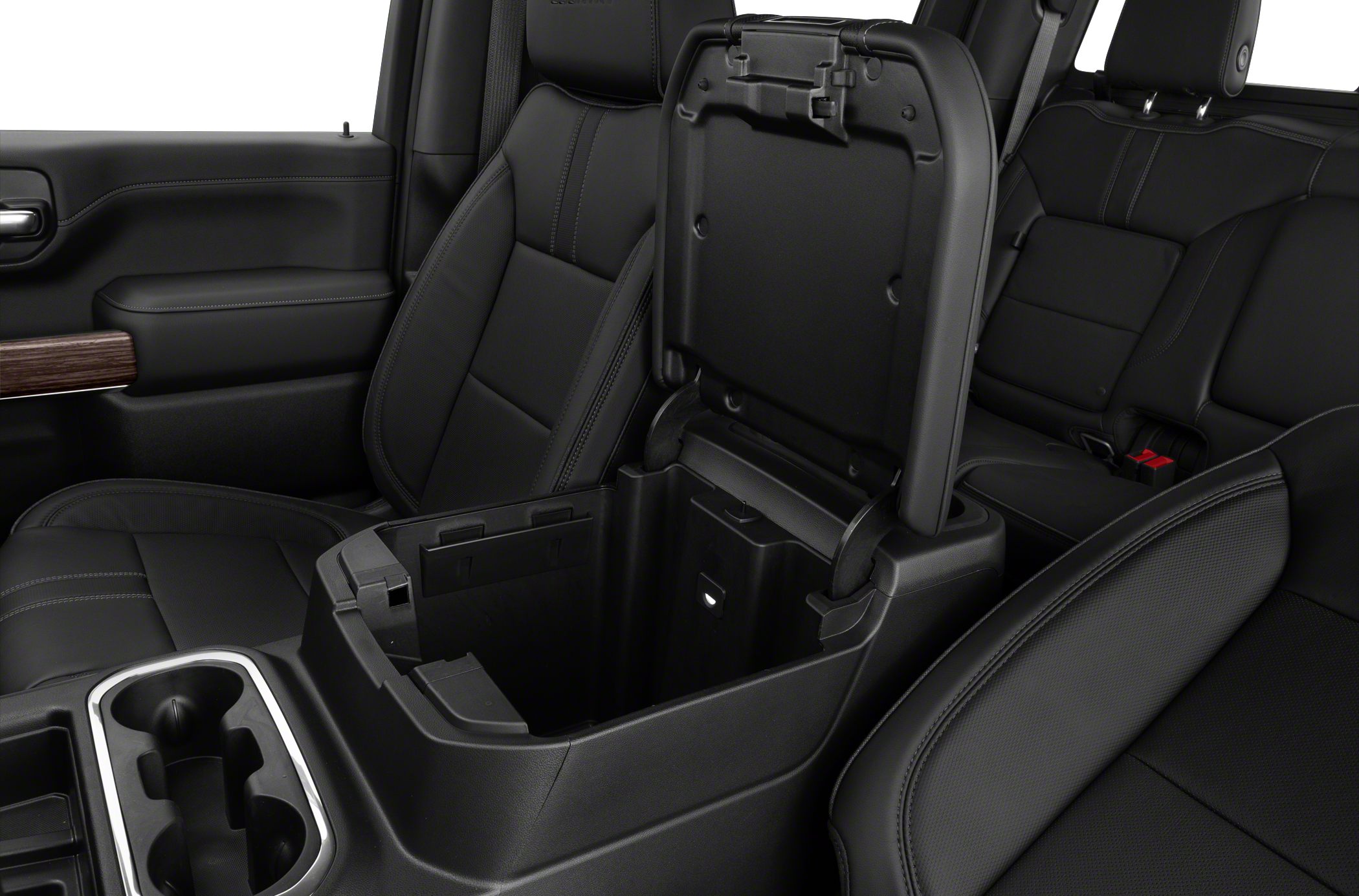 Open center console storage and black leather seats in a double cab truck interior