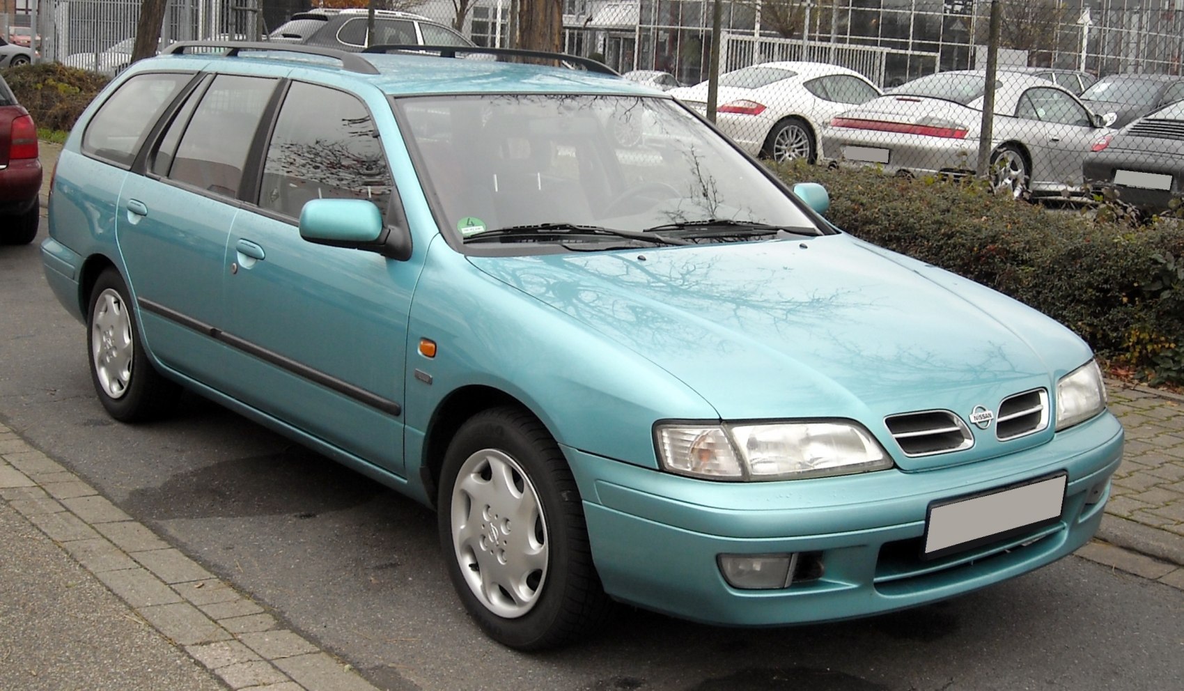 Blue station wagon with front-side view and classic headlight design