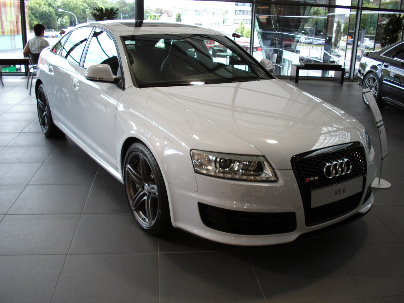 Aggressive front grille and LED headlights of a sedan.