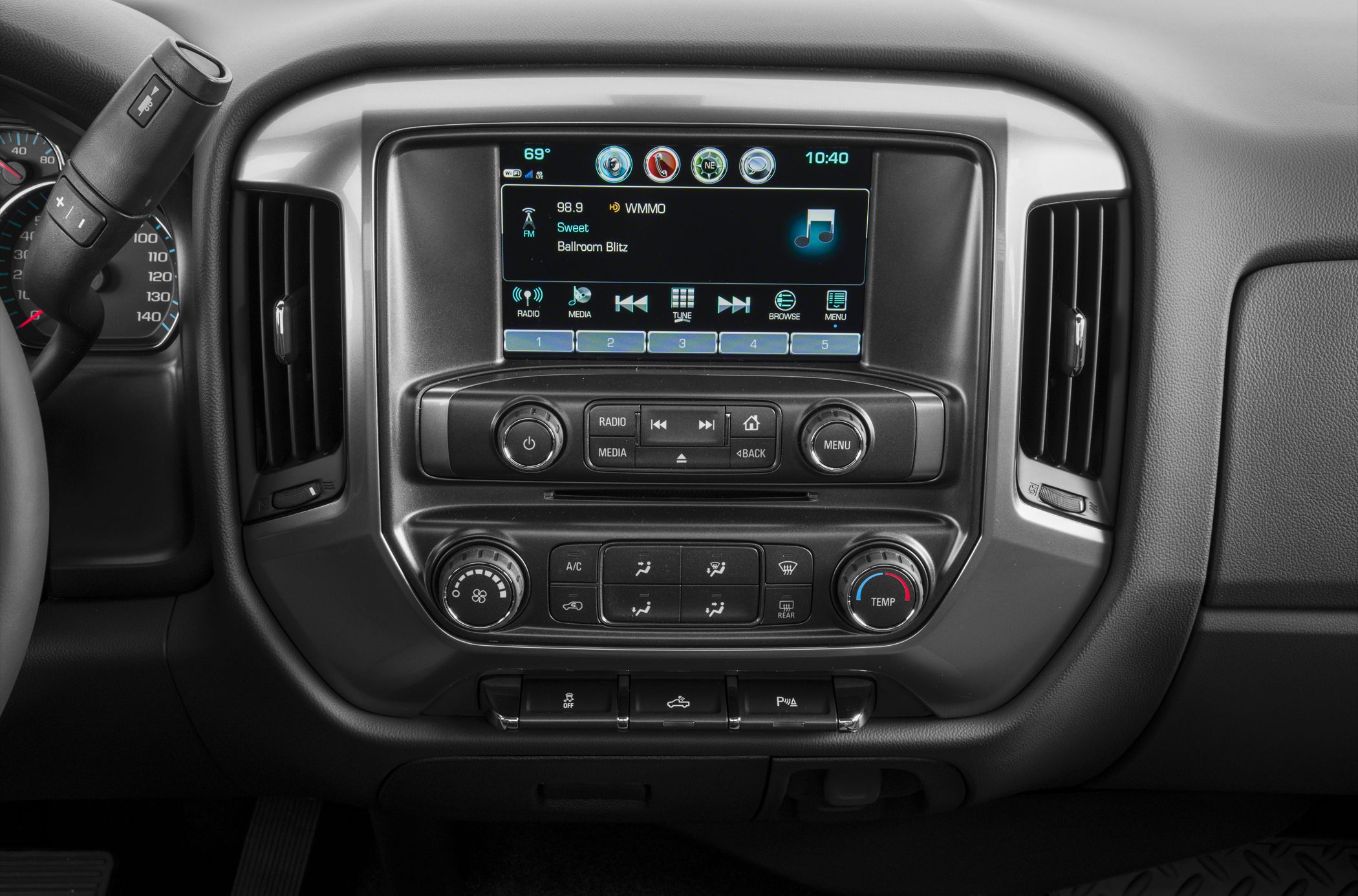 Dashboard infotainment and climate control console with media and temperature dials