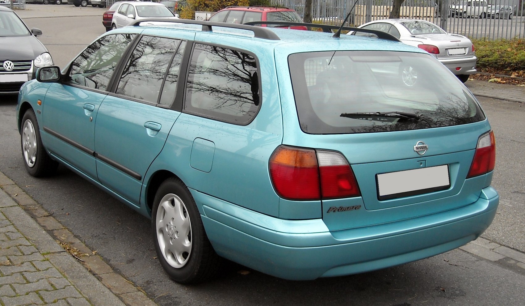Rear and side view of a station wagon with roof rails and tail lights