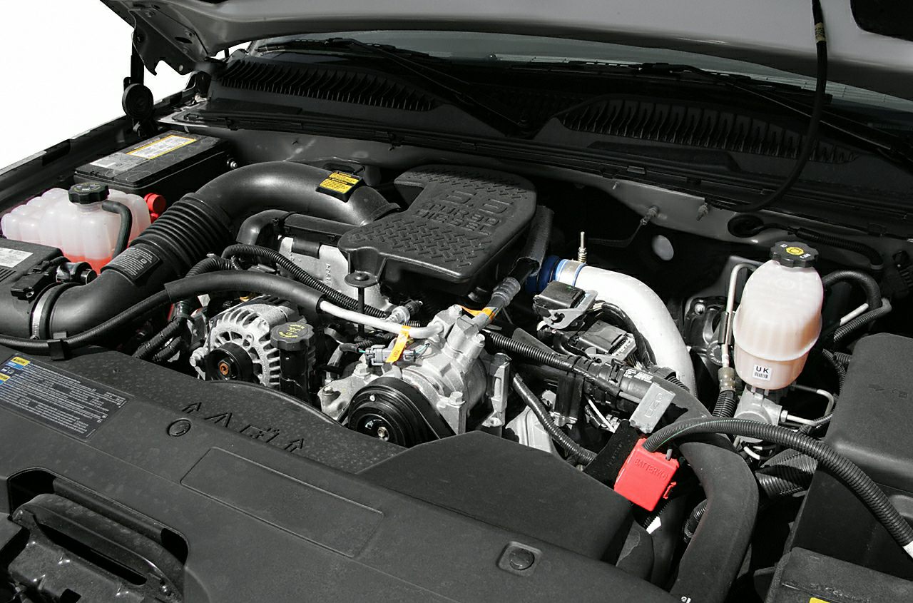 Engine compartment showing detailed truck engine components.