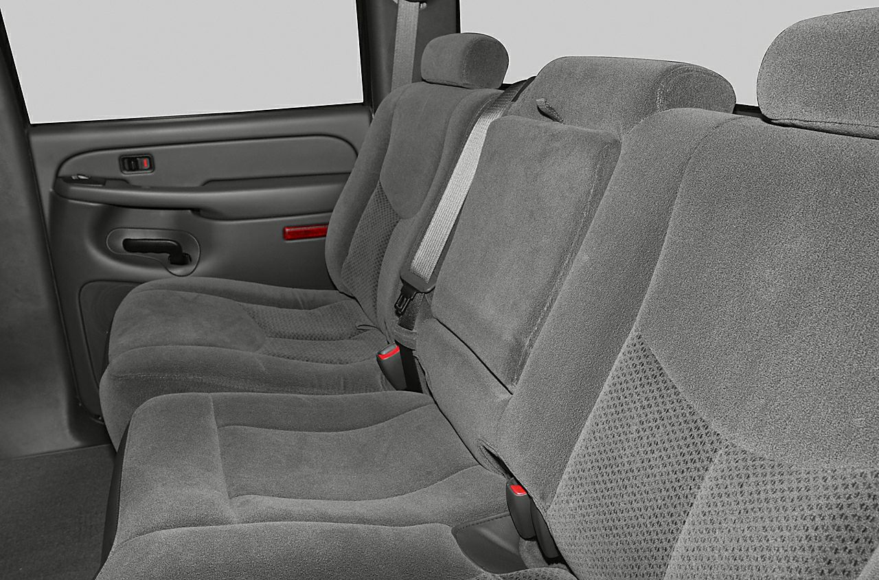 Cloth-upholstered rear bench seat with seat belts and armrest