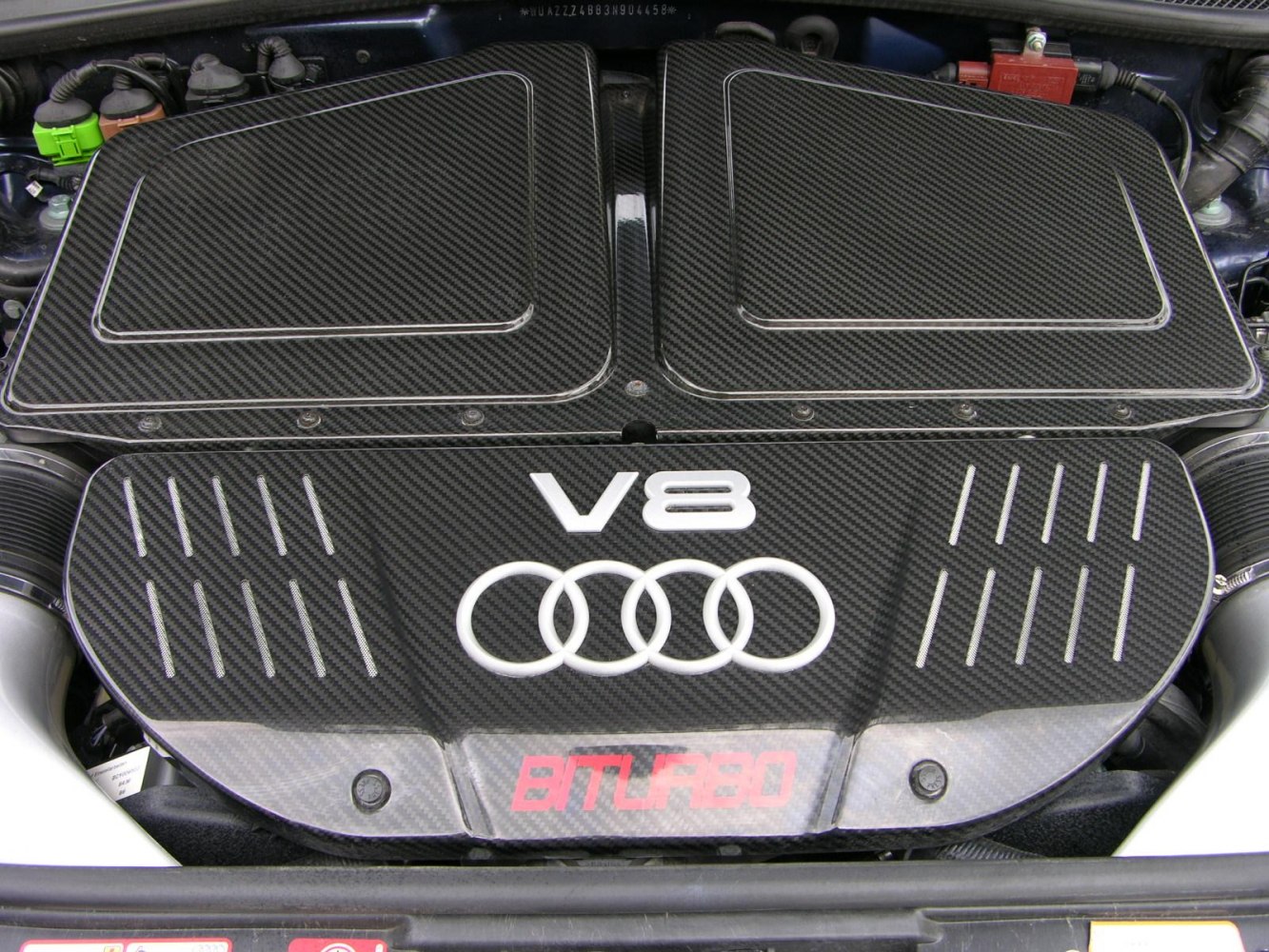 V8 engine with carbon fiber cover and Audi rings logo
