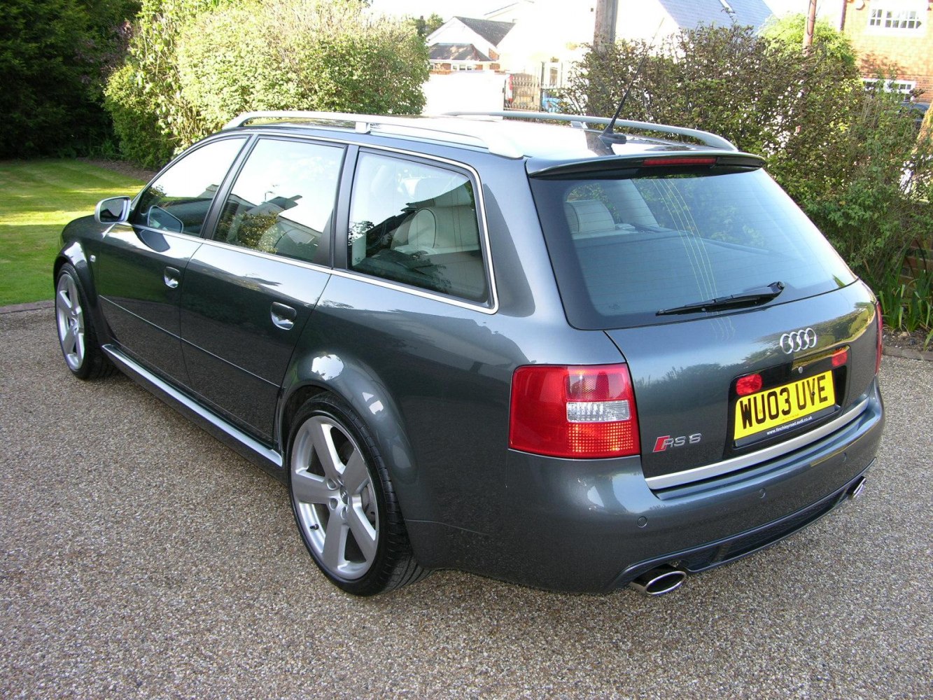 Rear side view of a sporty wagon with dual exhaust and distinct tail lights