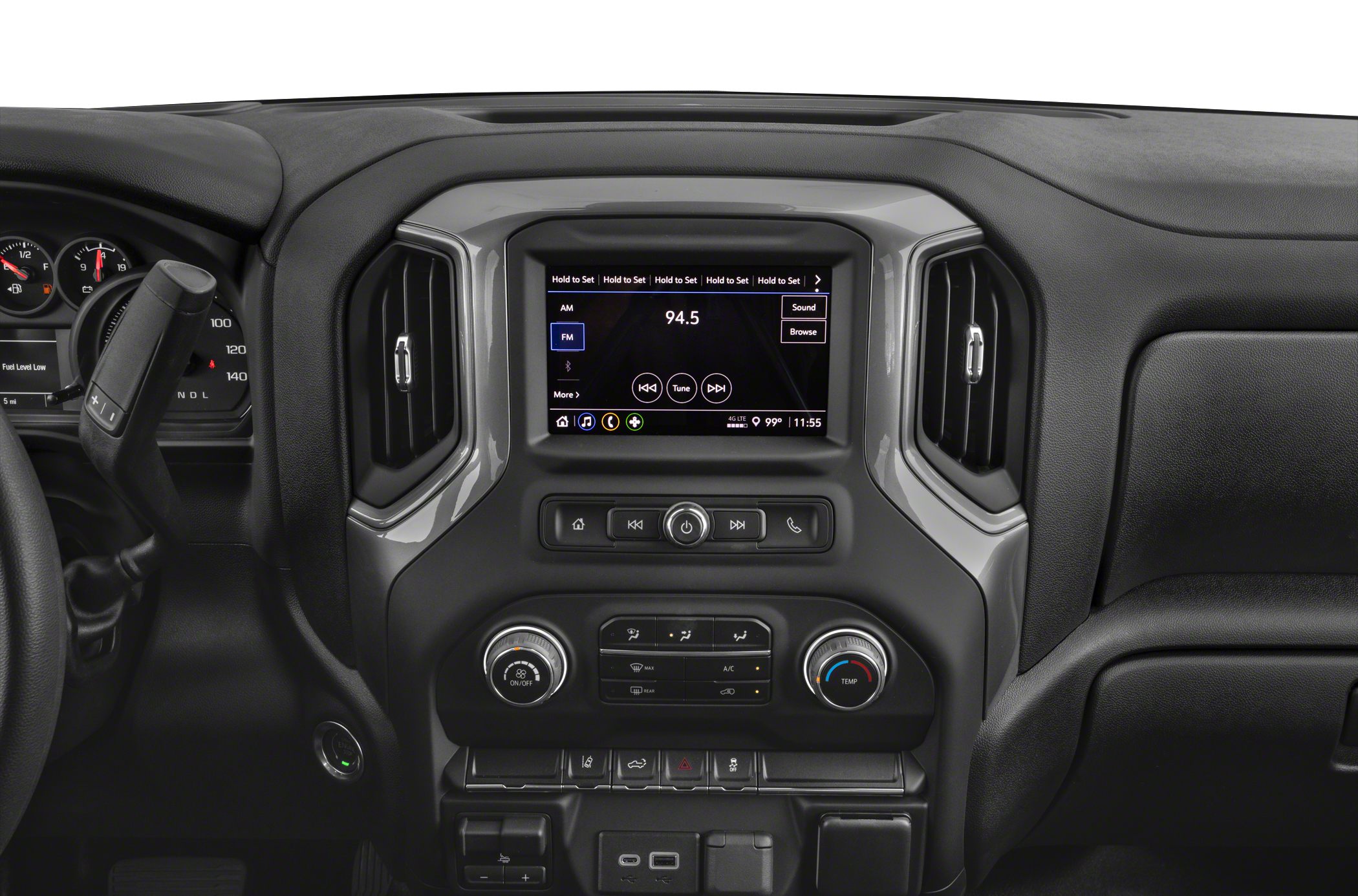 Infotainment touchscreen and climate control knobs in a vehicle dashboard