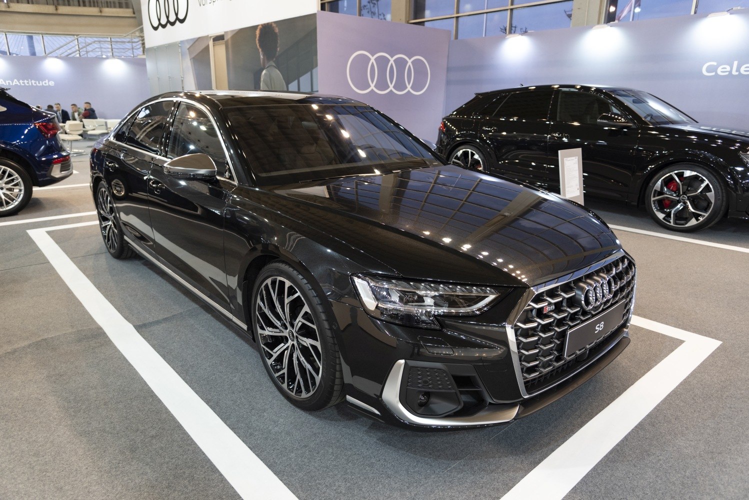 Front side view of luxury sedan with distinctive grille and alloy wheels