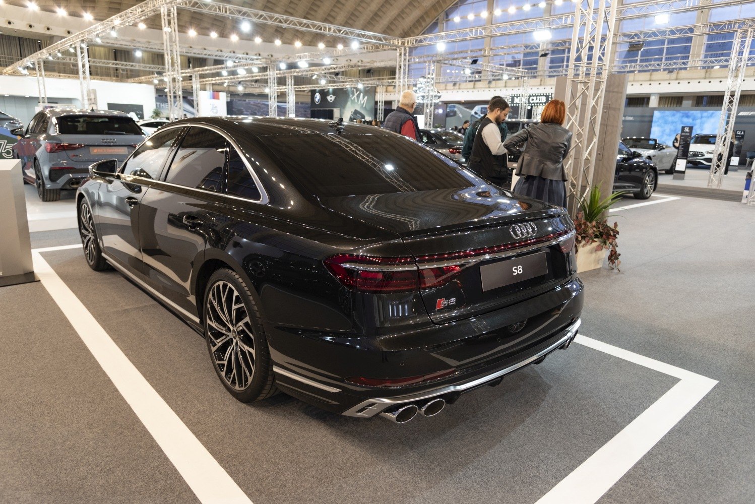 Rear view of sedan with LED taillights and quad exhaust tips